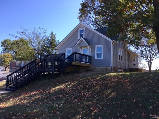This 1-1/2 story home has a sense of charm. Hardwood flooring with lots of updates. Kitchen has country charm that features beautiful white cabinetry with black knobs.  The kitchen also features open kitchen shelves hung on a ship lap wall. Below the shelving a beautiful coffee bar area.  Upstairs is a bonus room with a bedroom. Off Street parking with a nice size deck. New roof, new windows and new siding.