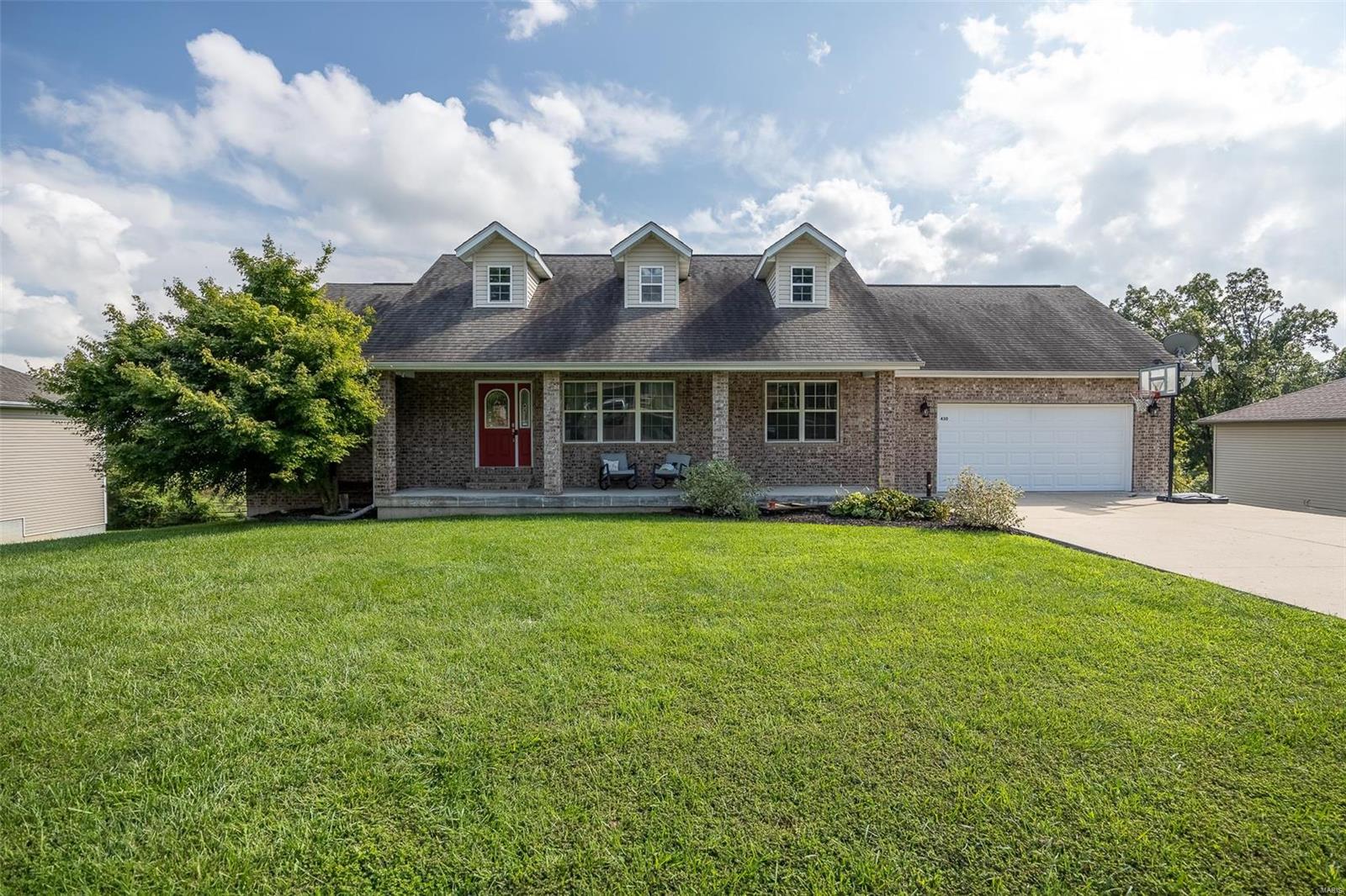If you are needing room to grow, this gorgeous brick-front home has space for everyone! Featuring 5 bedrooms, plus bonus rooms, you'll find this home offers more than 3300 square feet of living space. Spacious living areas can be found upstairs and down, with additional rooms for all your activities, including the perfect home office, craft room, workshop area and even a storm shelter and extra storage space. This home was thoughtfully constructed with a divided floor plan for extra privacy to the master bedroom and classic details throughout such as vaulted and tray ceilings. For those who enjoy spending time outside, check out the brand new deck and the covered front porch, as well as the large 1/3 acre lot with plenty of room to play. In the colder months, curl up and crank on the gas fireplace, guaranteed to keep you nice and toasty. No need to worry about finding the perfect home, this one is turn-key, like new with a variety of recent updates and everything you could need.