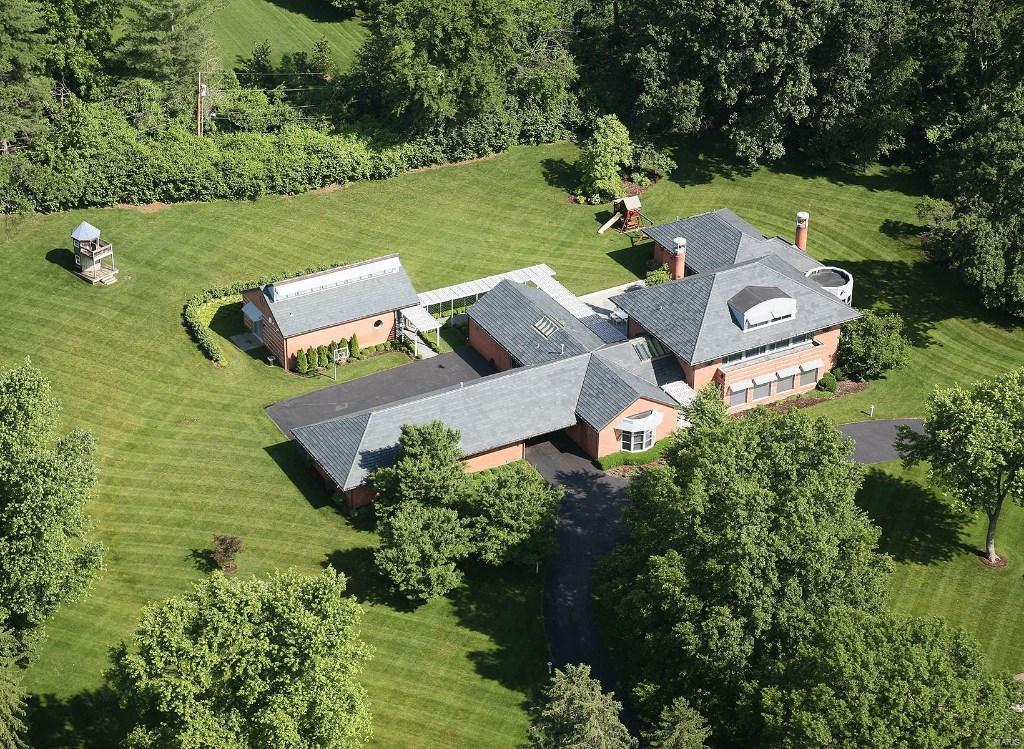 This newer contemporary home is set on 3 acres in the sought-after Somerset Downs neighborhood and designed by Louis Saur with a recent guesthouse addition. The U-shaped house is centered by a 25’x50’ blue stone patio with an inspiring great room as its centerpiece. Skylights and expansive windows wash the rooms in natural light & varying ceiling heights blend dramatic & intimate spaces. You’ll find two of everything in the chef’s kitchen with designer appliances, a center island, marble counter tops & custom maple cabinetry. The master suite is a sanctuary with a marble fireplace, His & Hers baths/dressing rooms, heated flooring & skylights. An entertainment center, wet bar, exercise room & en suite bedroom define the finished lower level. Additional features are a Ludowici tile roof, Lutron electronics, central vac, security, irrigation system, 5-car heated garage. 6,758sf on main flrs, 2,600sf in LL, 1,200 sf in guest house combine for 10,000+ sf of luxury living.