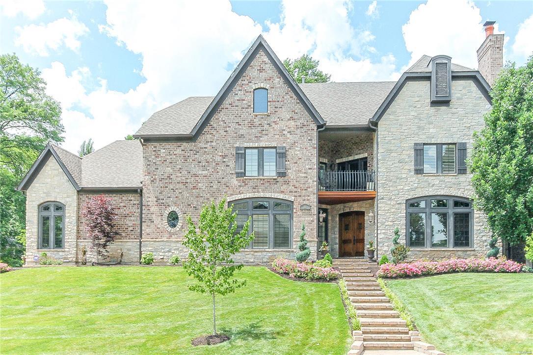 Exquisite details throughout this executive style home. Brick & stone elevation. Custom stone pavers. This is the home that you will enjoy living in. Stunning solid wood arched doors with visitor hatch. Elegant designer chandelier showcases the two story entry foyer. Warm wood adorns the gathering room/den featuring a cozy fireplace. Open concept dining room. Two story great room with soaring stone fireplace. Cooks delight in the chefs kitchen, upgraded built in appliances, serving island, walk in pantry & wine area. Main level master suite with remarkable custom closet system, morning/evening bar, spa like bath. Commercial grade elevator services all three floors. Upper level offers an observation or cigar balcony plus 2 bedrooms with private baths & enormous walk in closets. Walk out lower level with fireplace and bath/bar rough ins. 3 car oversized drywalled garage with service door. Custom patio, irrigation system, professional landscaping. Outstanding location. Additional Rooms: Mud Room