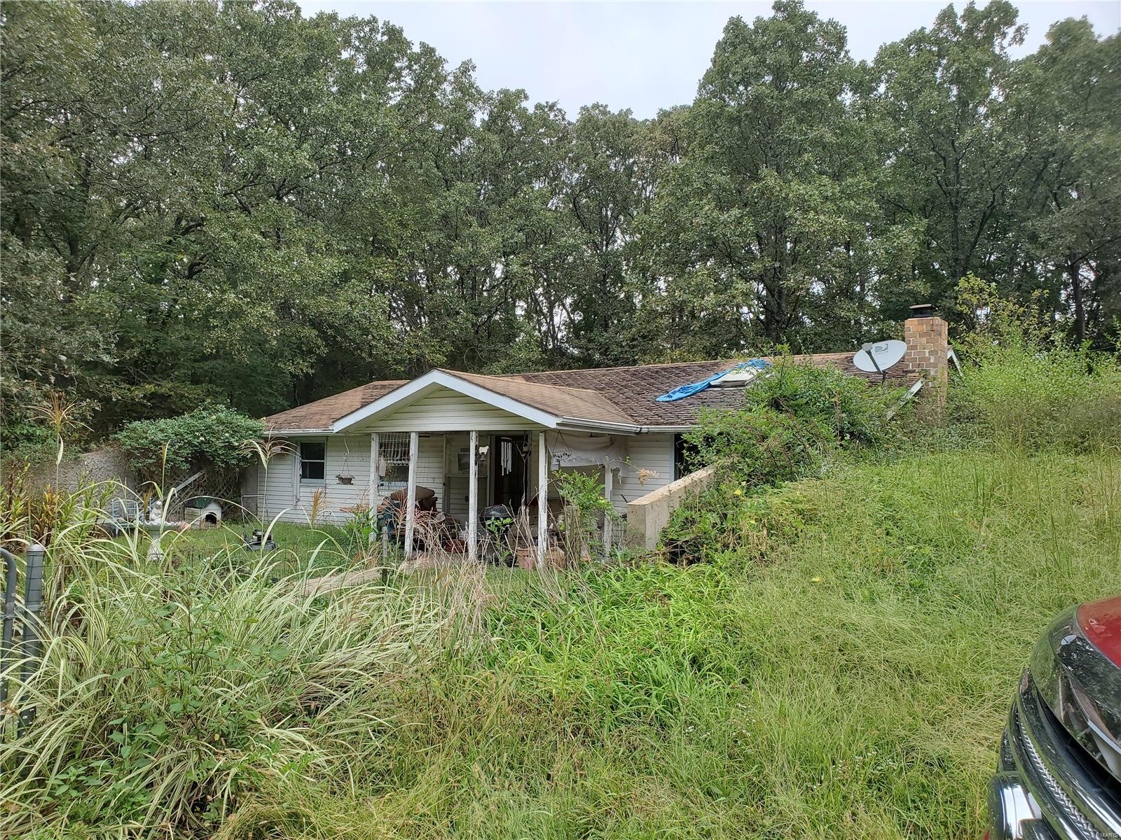 3 bedroom, (1 bedroom does not have a window) 2 bath earth home on 4.7 acres. Home offers open kitchen & living room with wood burning fireplace in living room. Property is wooded and has shared driveway. SOLD AS IS!