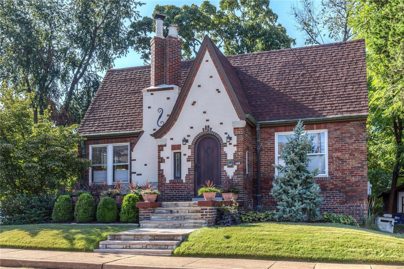 Absolutely charming home on cul-de-sac in the heart of Maplewood. Meticulously rehabbed with attention to detail. Beautiful woodwork, cove moldings, arched doorways, hardwood flooring, stained leaded glass windows, copper gutters. Many updates include architectural roof, water heater, humidifier, C/A, Electric panel, garage door opener. Possible expansion with walk-up stairs to a large floored attic with a 10' ft. ceiling 3 nice windows. Wood-burning fireplace for those cold nights. Sunroom/office with southern exposure. Large basement with work-out area and Sauna! Oversized attached 1 car garage. Private patio with fountain, custom privacy fence. Professionally landscaped yard filled with many perennials. Quiet cul-de-sac location that is close to everything - walk to downtown Maplewood! Additional Rooms: Sun Room
