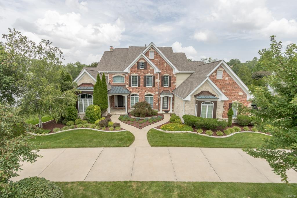 Drive up to the circle drive to this brick and stone home w/elegant French country appeal on premium lot in sought after Greystone, Walk-in to wood floors and soaring 20 foot ceiling, natural light pours into the great room thru the wall of windows - outside find one of the best yards w/heated pool and lush landscaping, all backs a beautiful stretch of common ground. Back inside find more than 6500 square feet of living space w/5 bedrooms + and 4 full baths + 2 half baths. Work from home? You will love the main floor office w/french doors for privacy, transom window and 11 ft. ceilings. Main floor master w/updated bath. The large kitchen/hearth room is the ideal setting for gatherings w/granite breakfast bar island and white cabinets. Just outside find a sunroom porch to take in the private yard. Downstairs a large finished basement w/gas fireplace, and pool bath w/changing room. All new carpet, plus newer roof. Rockwood Schools! Now at 185.00 a sqft an amazing value in Greystone. Some Accessible Features Additional Rooms: Mud Room, Sun Room