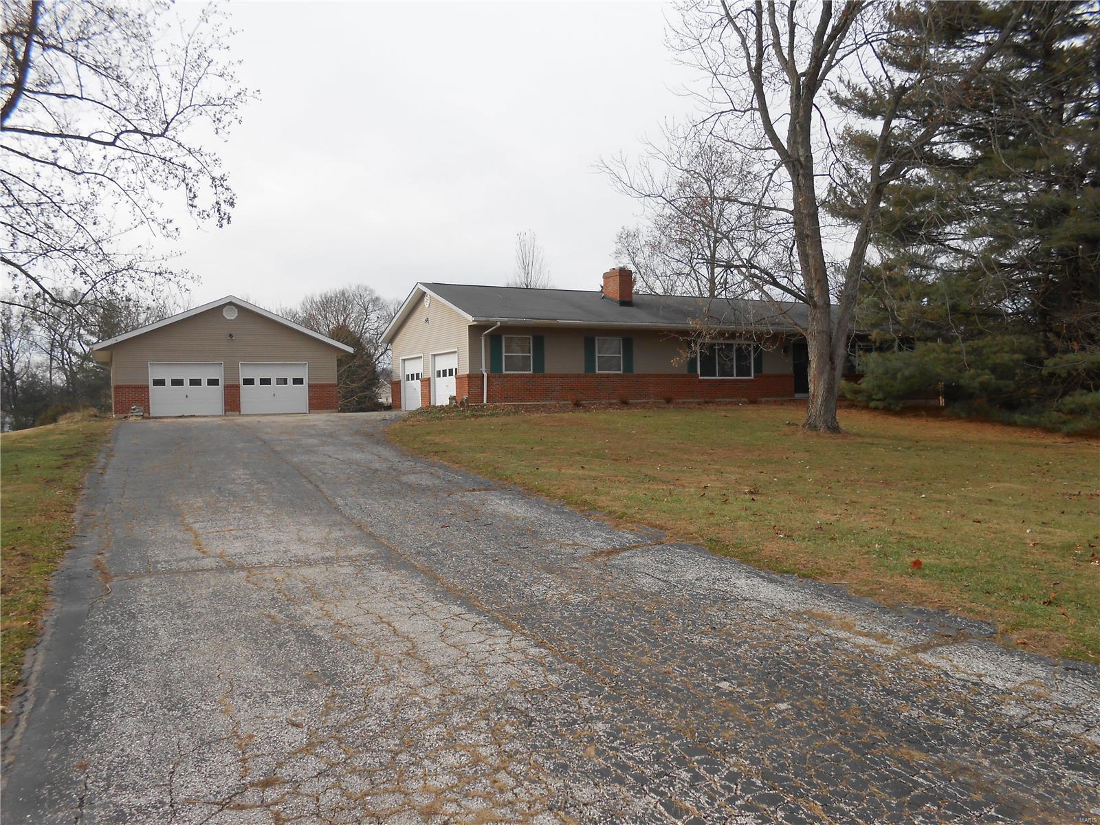 Move-in ready 4 bedroom 3 full bath ranch home.  Sitting on 1.879 beautiful park-like acres.  There is an attached over-size 2-car garage plus another newer over-size two car garage being used as a work shop.  Wood burning firep0lace in living room.  Partially finished lower level has a walk-out. New carpeting in the finished area which measures 27/x21 and could be used for a family room, game room or whatever you want. Large deck in back is great for entertaining.  Kitchen has been rehabbed and has slate-colored appliances.  Slate refrigerator stays, too! Sliding doors from country kitchen open onto the deck as do the sliding doors from the master suite.  There is so much to like about this home that you just have to see it to appreciate all it has to offer!