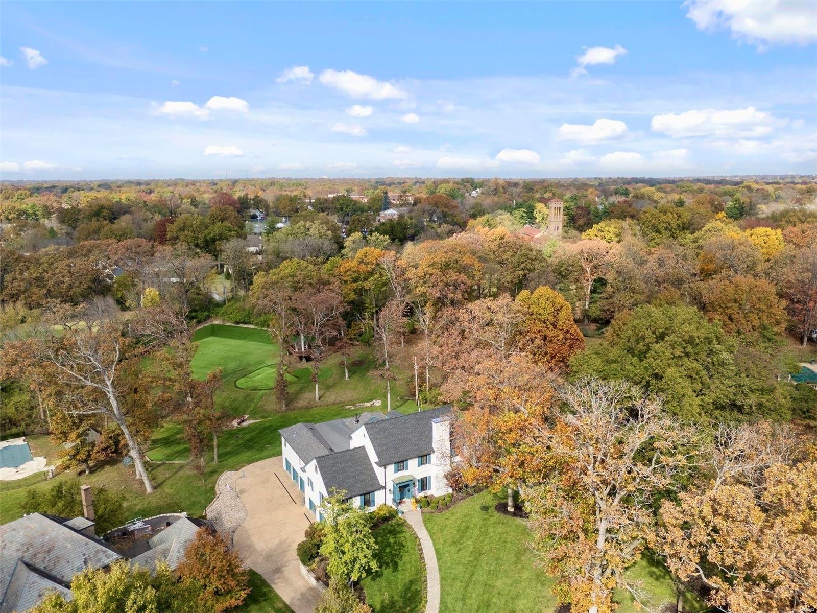 Discover this exceptional property, nestled on over 2 private acres with stunning views of lush tree lines and the adjoining Bogey Club golf course. The site is a playground for active families, complete with a turf sports field, a tree house, and a putting course. Expanded and remodeled in 2014, the home offers an open floor plan, expansive windows, and soaring ceilings, creating both a tranquil retreat and an entertainer's dream. The designer kitchen seamlessly unites the hearth and dining rooms with the outdoors through a charming screened porch and an elevated deck. The main level also includes a formal living room, gracious primary suite, office, and mudroom. Upstairs are three guest bedrooms, two sitting rooms and three full baths. The lower level features separate gathering and game rooms, a wet bar, a fitness room, an additional bedroom and bathroom, plus a five-car garage—each area opening to covered patios and a gently sloping backyard. This is a truly rare find! Additional Rooms: Mud Room, Sun Room