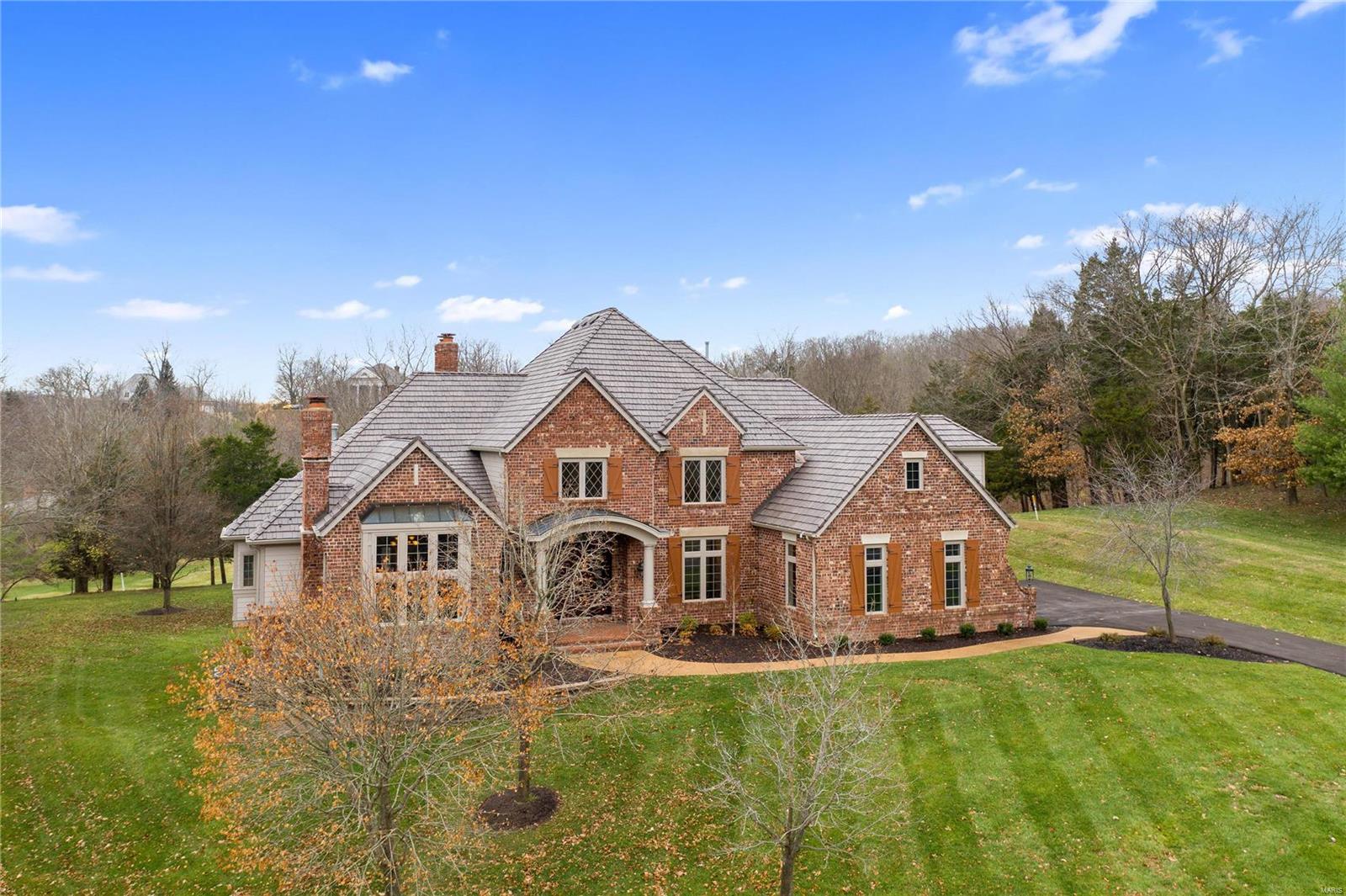 This elegant former Fischer & Frichtel display home sits on one of the finest golf course lots in Cedars Valley. Walls of windows at the rear elevation look out over the patios, the level yard and the Lewis & Clark golf course just beyond. Features include a sweeping front and conveniently located rear staircase, a fully paneled study with built-in cabinets, bookcases and vaulted ceiling. The main floor master is huge and features two walk in closets. The kitchen has Viking and Sub-Zero appliances, granite topped breakfast bar, a planning desk and a two-story hearth room with floor to ceiling stone fireplace. The walk-out lower level includes new carpet throughout, a fifth bedroom with bath, a wet bar and ample storage in the two storage rooms. Other noteworthy items all in 2020: new 50 year roof, new gutters, newer HVAC, newly refinished hardwoods, freshly painted all interior walls, ceilings and garage, new driveway, two smaller HVAC units.