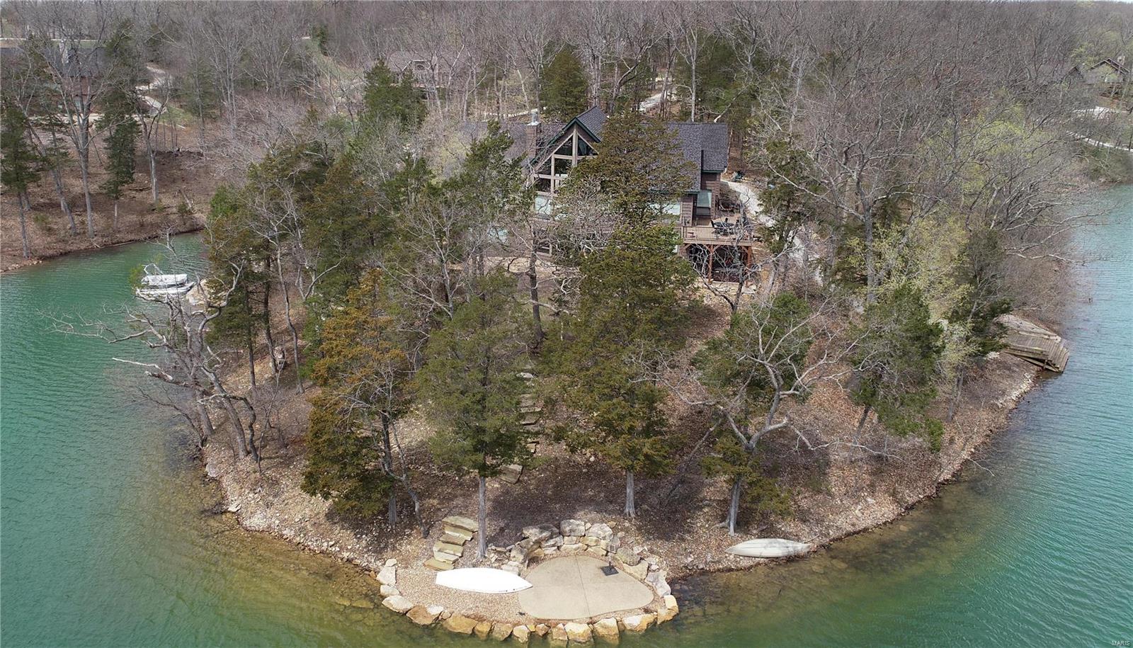LAKE ALPINE!! The ultimate in lakeside luxury living awaits! This custom-designed, 8-year-old (still like new) raised ranch-style home situated on a point lot boasts panoramic views of the 236-acre lake from almost every room in the house. As you enter the majestic 2-story double door entry, you are greeted by a wall of windows offering majestic views. The main level features a designer kitchen with an island counter and solid surface counters, all opening to a spacious great room with a floor-to-ceiling stone-front fireplace, and the prow of windows providing gorgeous views and plenty of natural light. Separate dining area opens onto spacious deck offering views of the lakeside dock, patio and beach area. The main-level master suite features a separate den/office. Walkout lower level features 3 additional bedrooms, large family room with gas fireplace, wine cellar and plenty of storage. Oversized 3-car garage with additional storage. Fully furnished, ready to start enjoying Innsbrook! Suitable for Bed/Brk