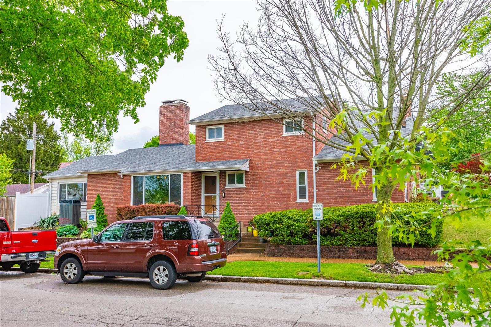 Your forever home awaits in this gorgeous Lindenwood Park, multi level living home sitting on corner lot overlooking Lindenwood Park. MAJOR UPDATES: Roof in 2017, water heater and 95% efficient HVAC-under 5 years old.  Take a stroll to Ted Drew's or local Bistro's/entertaining spots...Better yet stay home in this welcoming 3 bedroom home with updates galore. You're greeted at the entry foyer by views of the sprawling living room with bamboo flooring and wood burning fireplace plus a sneak peek into the custom kitchen offering abundance of quartz counter space, stainless steel appliances, tile flooring, breakfast bar and attached dining room. Separate-formal dining room walks out to the fully fenced, level yard. Main floor completed by a full bath, master and additional bedroom. Hardwood continues to the upper level where a second master bedroom, bath awaits. Finished lower level offers second living room, fireplace and additional living space PLUS storage. Curb appeal + warmth inside!