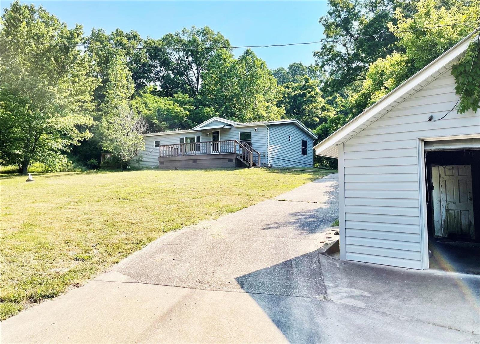 This has been a loved location for many years...9+ Acres with 3 bed/2 bath home, detached garage, paved driveway, carport in back for parking AND a deck for enjoying the beautiful view. So much potential and priced to sell! Call to see this one today!