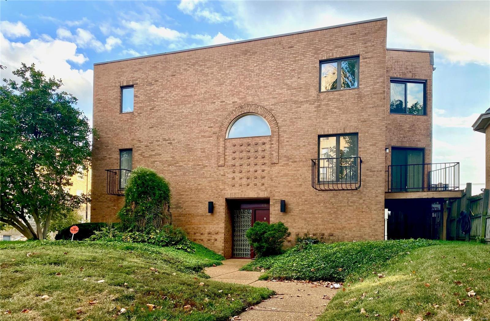 Here is an attractive, CWE townhouse/condo, featuring 3 bedrooms plus an office, and 2.5 baths. The unit has a lower-level 2-car garage with new garage door; an in-unit laundry room; zoned HVAC; spacious rooms; a delightful balcony adjoining the living room; lovely hardwood floors in both the living room and dining room; a sizable eat-in kitchen; new carpeting; fresh painting throughout; and a primary bedroom suite with walk-in closet. The unit features a landscaped front yard, and is located in a boutique, 3-unit complex with outside, professional management. This property has an excellent location, directly across the street from a pharmacy, dry cleaner, and convenience store. Enjoy a 2-block stroll to Whole Foods, a 3-block bike ride to beautiful Forest Park, and a 3-block walk to the Wash U Medical Campus or the Cortex Innovation District. Buyers should note that some repairs will still be needed to the original windows and thermal seals, and will not be corrected by seller. Location: City, Corner Location, End Unit