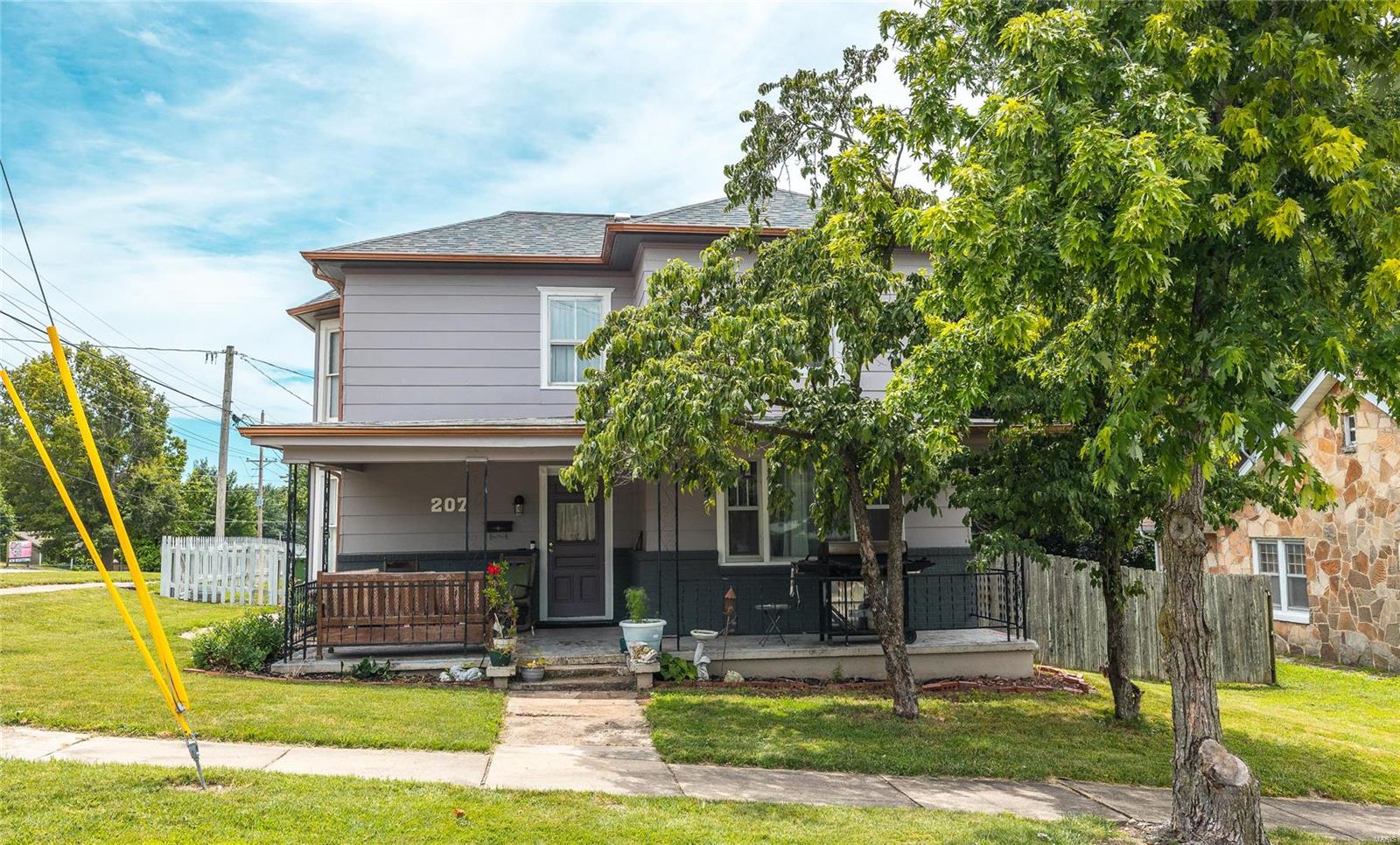 Step back in time with this charming 1890-built home, beautifully blending historic charm with modern amenities. Situated on a corner lot, this 2,115 sqft residence boasts elegant hardwood flooring in the dining room and tile in the entryway and kitchen. The expansive living room, features a cozy gas fireplace, is perfect for family gatherings. Upstairs, discover four spacious bedrooms and two well-appointed bathrooms An attached two-car garage provides convenient access to the basement, offering additional storage space. This unique home is a timeless treasure waiting for your personal touch! Seller to pay closing costs and also offering a 1,500 painting allowance!!!