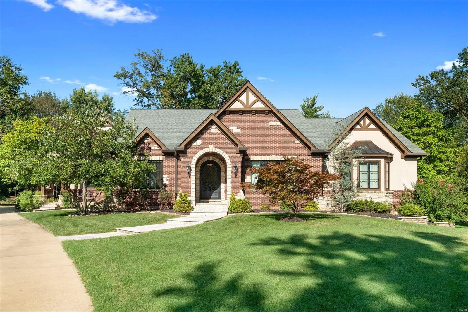 Custom built home in 2005 on .75 lushly landscaped acres with a lovely geometric pool and waterfall. This home was designed for main floor living with both a master suite and guest suite on the main - additional in laws suite on the upper plus a generous bonus/craft room that could be used as a pass through bedroom. A 4th bedroom suite in the finished walkout LL. This center hall floor plan offers LR, DR double-island kitchen open to hearth room, half bath, laundry, mudroom and an oversized 3 car garage on the main with easy access to the pool off hearth room. The master bath can also be closed off to offer guests a pool bath. Driveway access to McKnight Road makes entertaining easy at 17 Ladue Manor. Walk to Reed Elementary and all that the city of Clayton has to offer. Easy access to 40/64 thoroughfare.