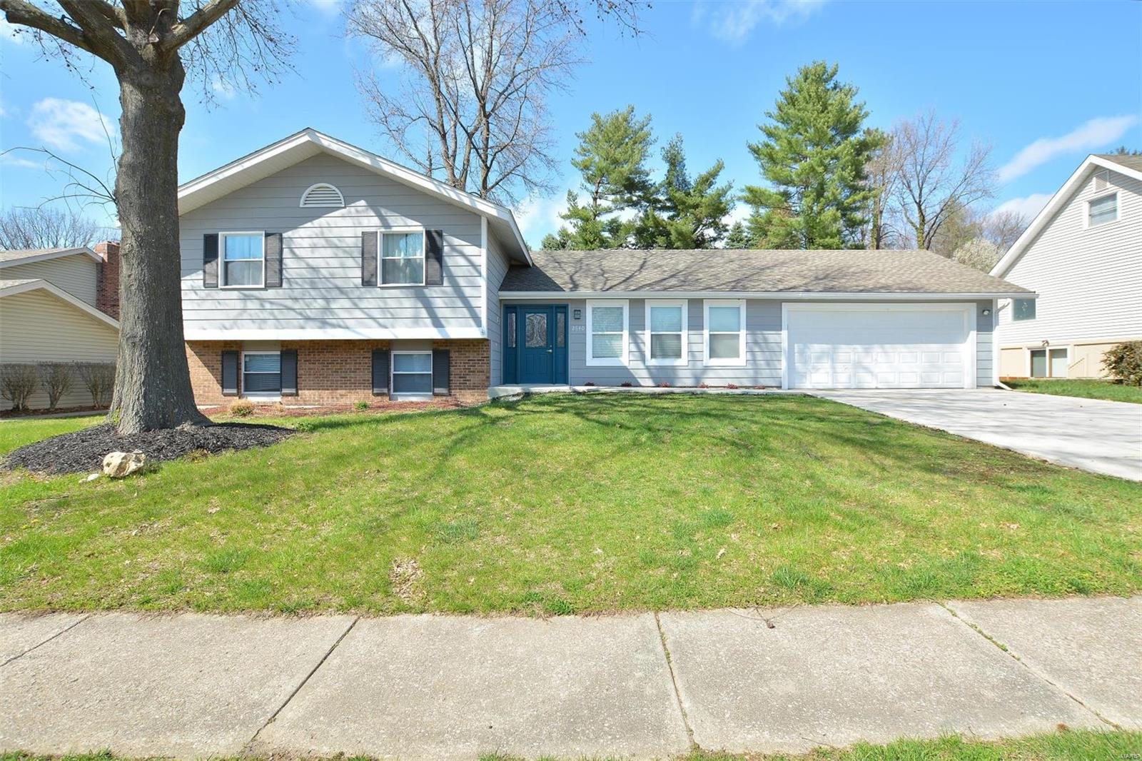 Welcome to this updated 4 bedroom 2 bath home in the Heritage neighborhood. Oversized 2 car garage w/builtin workbench. Beautifully remodeled kitchen with center island and open floor plan. Front door and Garage entrance are level with main floor. No stairs to kitchen which is common in multilevel. Over 1800 sf of living area. NEW OR NEWER..Exterior: Roof, soffit, fascia, driveway, walkway, doors, patio, paint Interior: kitchen cabs, counter tops, some appliances, flooring, doors, windows, bathroom. Lower level has wood burning fireplace, full bath, bedroom and laundry room. Storage can be added under the stairs and in laundry room. Upper level has a large master, 2 other good sized rooms and full bath. A great house for a family get together and entertaining! French doors open to the huge concrete patio. Lrg yard is partially fenced. Tree lined streets. Convenient location to restaurants, shopping, Hwy 70 and 364. Francis Howell Schl Dist. Direct access path to Katy Trail Agent Owned