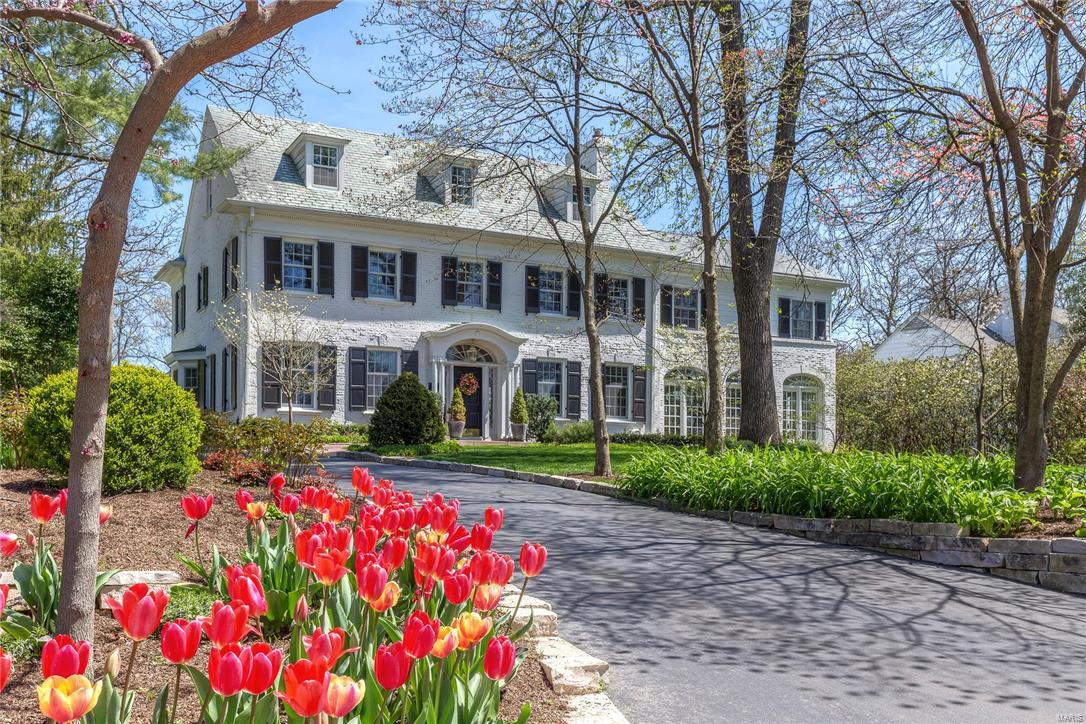 Stunning Georgian Colonial home in highly desirable Fair Oaks blends original charm w/ new additions for more casual living. The European country kitchen/hearth rm expansion is absolutely over the top w/ travertine stone floor, massive fireplace, soothing colors, gorgeous counters, butlers pantry & fabulous bar w/stained glass inserts at the entry. The hearth rm overlooks the pool w/fountains at each corner, terrace w/firepit and is surrounded by lush landscaping. The oversize master suite w/fireplace and sitting area has a smashing bath and closet addition w/ a coffee bar and laundry built-in! The family room addition is surrounded by Palladium windows, has a box beam ceiling and opens to the outside for entertaining. Graceful arched entries from the original home are repeated in the additions making the flow seamless. The updates & renovations throughout allow for a more contemporary lifestyle yet still preserve the historic style & integrity of this gorgeous Ladue home.
