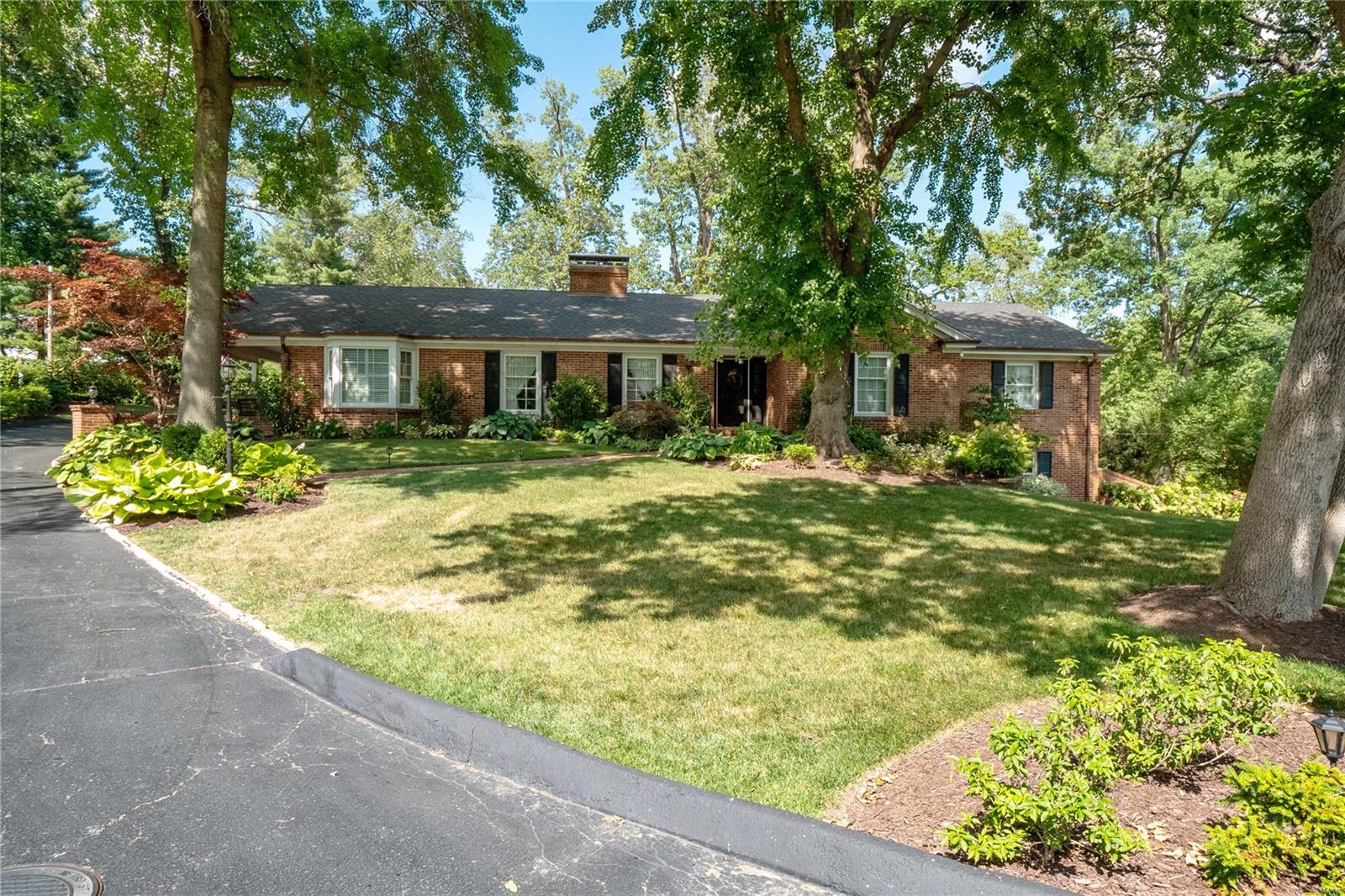 Sprawling ranch in quiet & highly sought-after Forestgreen Estates. Incredible location in Ladue School District in a private, park-like setting. Spacious entry brings you into the Formal DR & den, perfect for an office. Expansive kitchen feat. custom cabinetry & breakfast rm. Transition into the charming LR w/ gas fireplace that opens to the Huge FR with wall of windows & access to patio. Large Main Flr Primary Suite w/ lux bth feat. huge walk-in shower & walk-in closet. Two additional main flr bedrms & full hall bth. Lower level walk-out offers tremendous additional living space w/ lrge recreation rm with a wet bar, 4th bedroom, stunning full bth & half-bth. Plus lrge bonus rm & spacious laundry rm. Private yard provides ample green space surrounded by lush landscaping & an expansive patio ideal for entertaining. Two-car garage & covered side porch. Convenient location close to Country Clubs, schools, dining & shopping. This home has it all!