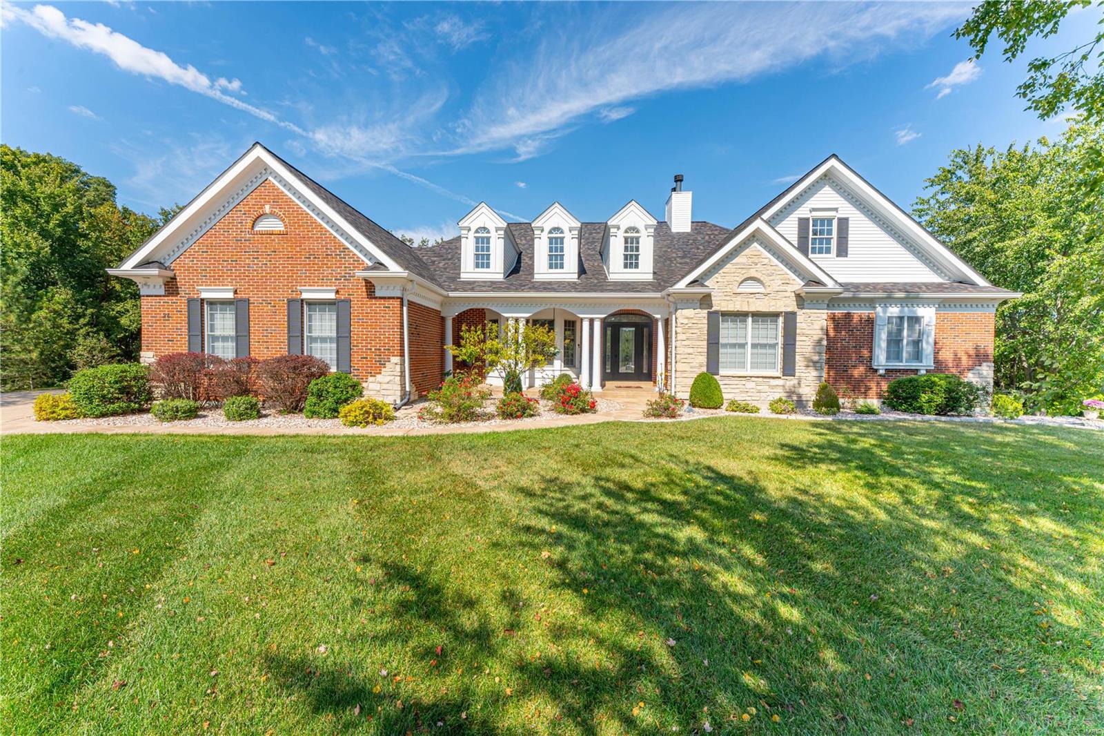 This exquisite built custom atrium ranch sits on .88 acres in a peaceful cul-de-sac, offering a private heated inground pool surrounded by lush trees & an expansive patio. A large deck overlooks the sparkling water, creating a true backyard retreat. Inside, soaring coffered ceilings in the great room & dining room lead to a sunlit atrium, enhancing the open & airy feel. The spacious main-floor primary suite features a luxurious bathroom, while two additional main-floor bedrooms provide ample space. Designed for elegance & function, this home boasts WOLF appliances, a SUB-ZERO fridge & stunning hickory floors. The gourmet kitchen is outfitted with double ovens, top-tier cabinetry & extended center island. Enjoy programmable auto blinds throughout. The LL offers a fourth bedroom, a media room w/ fireplace, billiard room, exercise room, & wet bar. With over 5,000 sq. ft. of finished space, an oversized 3-car side-entry garage, this home blends luxury, comfort, and timeless craftsmanship!