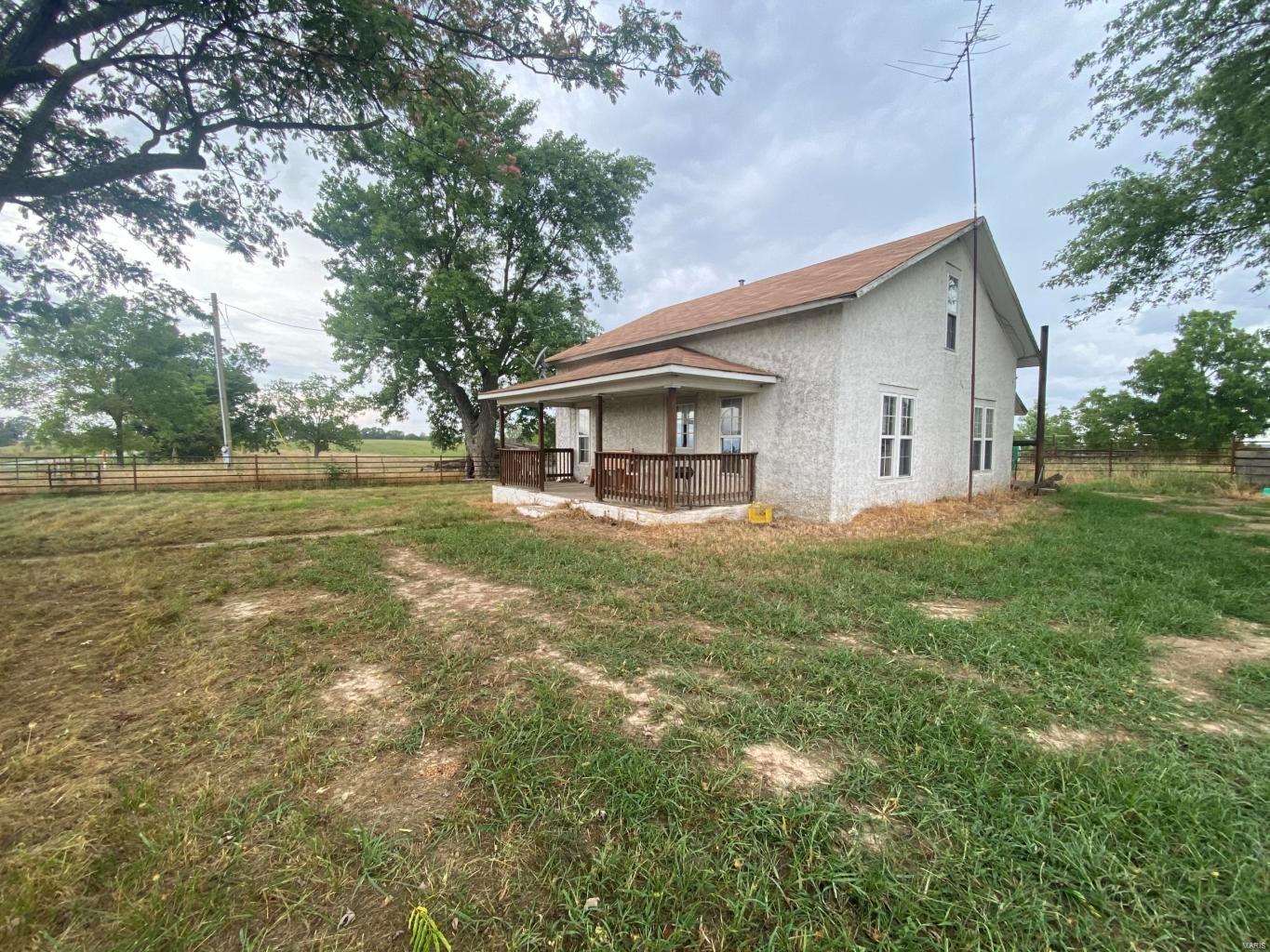 Rare find in the Ozarks! This property has so much to offer. The 80+ acres is livestock ready and on pavement! Multiple Ponds-two being spring fed, new perimeter fence and cross fences, hayfields, pasture, along with working facilities/pens. Land is mostly open with scattered trees for shade. The farmhouse is 4 bedrooms, 1 bath with open concept kitchen/dining area. New rustic cabinets, newer counter tops, central heating and air are a few of the bonus features of the home! Don't miss this opportunity!