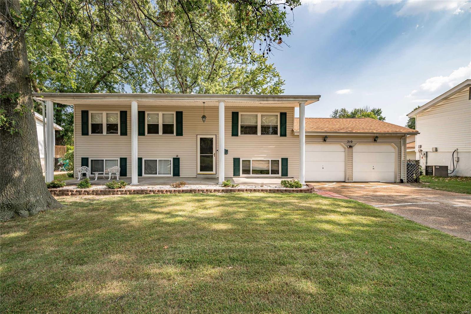 Fantastic 4 bedroom split foyer.  Great curb appeal!  Gorgeous custom front door unit installed. Full length front porch with stately columns!  2 car oversize garage.  Nicely updated kitchen with center island and Lazy Susan that is open to the dining room and breakfast areas.  Double doors from the dining area to a 17X14 deck with steps to a large patio.  Stairs from the dining room access a glass enclosed 3 season room behind garage that is also accessed from the lower level and garage.  Living room and main floor bedrooms all have hardwood flooring.  Huge L-Shape family room and sitting area with a corner wood burning fireplace in the lower level.  The lower level also includes a spacious master bedroom and full bath.  New roof installed in 2019.  Over 2100 square feet of living area not including the 3 season room.  Great value!  Hurry it won't last! Additional Rooms: Sun Room