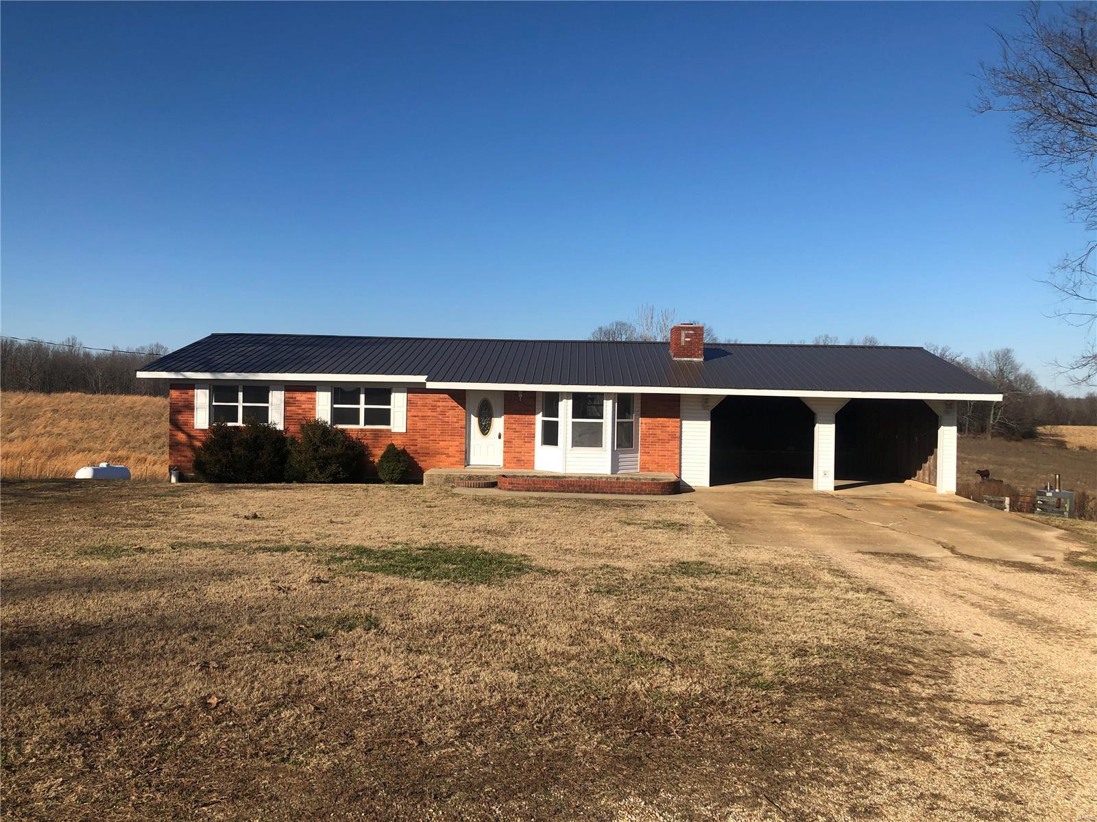 Beautiful Brick in country setting, private.  Relaxing views with this 3-2.5 with 2 kitchens.  Large back deck, large carport and a Hardy wood furnace.  An additional large acreage is possible upon request.  $105,000.