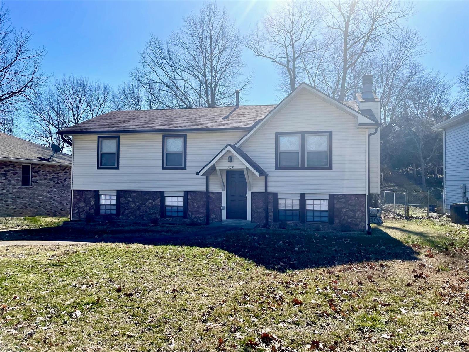 This 3 bed, 1.5 bath home has been rehabbed with all new flooring, fresh paint, many new light fixtures/fans, new water heater, added half bath in basement, new landscaping, updated plumbing and electric service, and added deck reinforcements!  The upper level features a main living area with vaulted ceiling and floor-to-ceiling stone fireplace, kitchen with new microwave, refrigerator, and dishwasher, dining area, 3 bedrooms, and a full bathroom with tub/shower.  Basement has another family room, laundry room, new half bath, and 2 car garage.  The elevated deck off the dining room overlooks the fenced private backyard.
