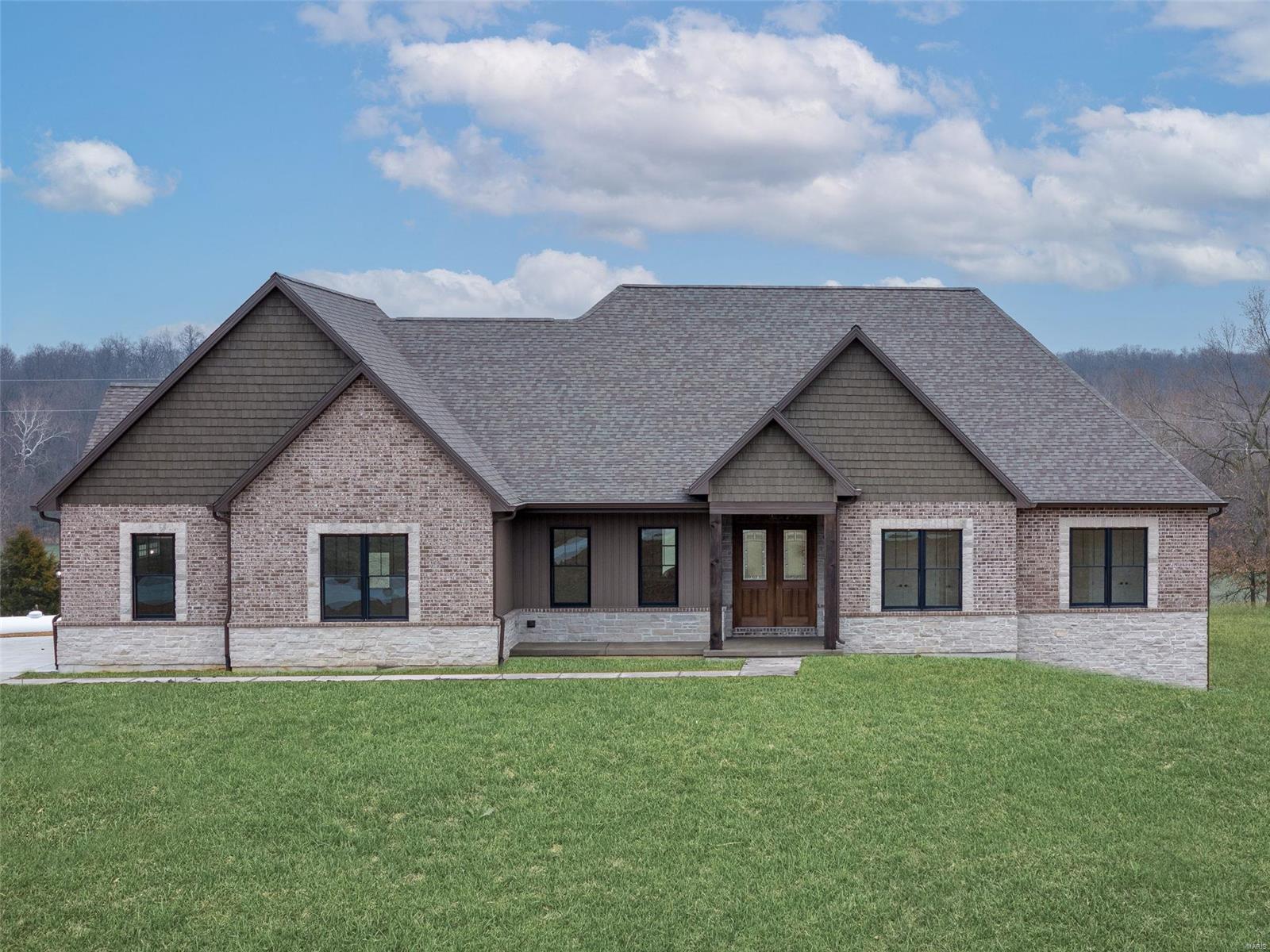 A brand new custom-built ranch home on acreage in St. Charles County is a remarkable find! Lucky for you, we have the perfect place right here. From the 5 acres of postcard-perfect views, to the flowing layout of the 2,650 square feet of exquisite living space, this home has it all! As you enter into the expansive great room you can't help but notice the soaring ceilings, beautiful wood floors and cozy stone fireplace. The enormous kitchen island has room for your whole family to gather and enjoy a wonderful meal, or you can enjoy your dinner under the massive vaulted covered patio surrounded by the ambiance and warmth of the wood burning fireplace. Retreat to the Master Suite after a long day. No expense was spared. A stand alone soaker tub, dual sinks and a master closet that would have most celebs jealous! Two other bedrooms, a full bath and a half bath are also a must see. A three car oversized garage and a side walk-out basement finish off this beautiful place you could call home.