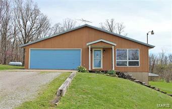 Want a home with acreage and a shop? Look no further! Here is a home with 6 acres +/- with paved road frontage. This home has approx. 1837 sq ft. The kitchen offers custom built maple finished cabinets which on the lower shelving is all roll out drawers. On the main level there is 1 bedroom and a full bath. On the lower level is 3 rooms that are being used as bedrooms, a full bath and features a 30x17 family room with lots of windows and 2 separate walkouts. Also in the basement is a canning kitchen with a cold cellar. The utility room is located near the full bath which adds convenient. There is a nice covered deck of the back of the home adding lots of privacy. The 30x30 shop has 12’ ceiling with a small loft area. There is concrete flooring with 220v service and compressed air. Great for those who love to tinker or could be turned into a master bedroom on the main level is an added room behind the garage. There is a private well and septic on the property. There are to many things t