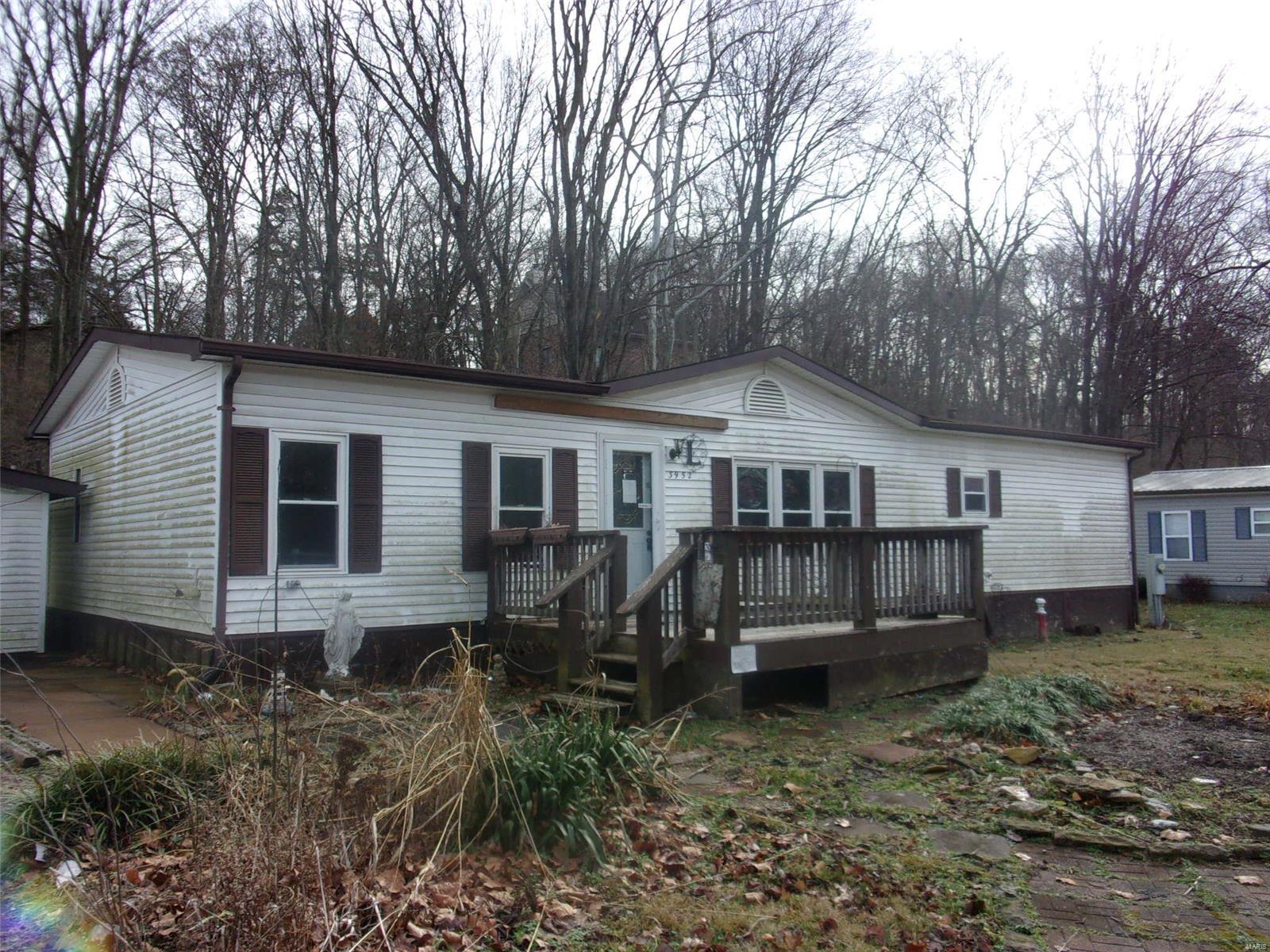 OUTSTANDING OPPORTUNITY!! Here's your chance to create your own piece of paradise!  Existing mobile is an excellent rehab candidate. Split floorplan offers a huge master suite, woodburning fireplace, open atrium great-room, and more! Great garage has room for your toys, but also a BAR and IT'S OWN BATHROOM! Great covered deck in the rear, fenced yard, and super quiet location make this one a WINNER! Schedule a showing today! Property is to be sold in its current as-is condition with no warranties or representations by the Seller. Seller will not make repairs nor provide any inspections. Seller's addendum is required after terms of sale are agreed upon. Special Sale Contract (Form #2043) required. Proof of funds or pre-approval letter required with offer. SpecialListingConditions: Possible Auction