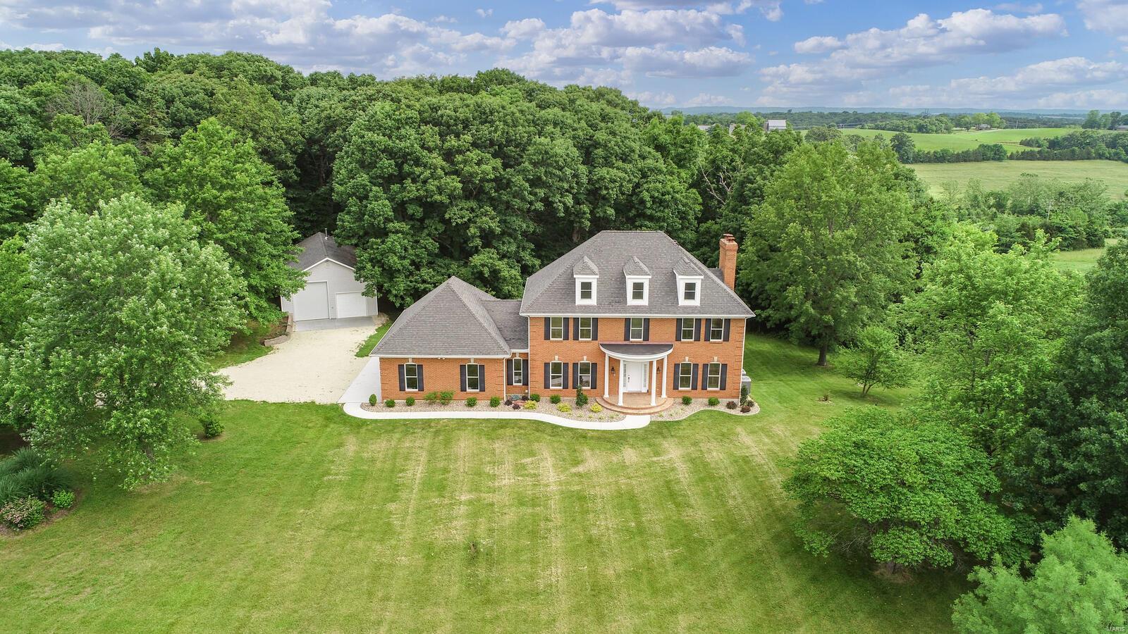 Elegant 2 1/2 story home is situated on 43 +/- acres w/GORGEOUS PANORAMEC VIEW ! GREAT FOR HORSES/RECREATION/FARMING/WEEK-END GETAWAY OR RESIDENTIAL! Land is mostly open pasture & some scattered woods. 28 x 48 detached outbuilding w/100 amp service, car lift, woodstove & concrete floor. Stepping thru the doorway of this beautiful home entering the main level offers a splendid foyer, formal living room & separate dining room. Kitchen w/custom cabinets, quartz tops, pantry, backsplash, stainless steel appliances & breakfast room. A great room w/wood burning fireplace, leading to large deck. Laundry room & 1/2 bath. Upper level finds you Master suite w/walk-in closet, tub/separate shower & dual sinks, 2 add'l bedrooms, office & hall bath. 3rd level offers a spacious rec room, office etc.. Walk-out lower level features a family room w/wood burning insert fireplace. mud room & full bath. 3 car oversized garage & 1 tuck under garage. MUST SEE THIS PRIVATE SCENIC COUNTRY SIDE PROPERTY !