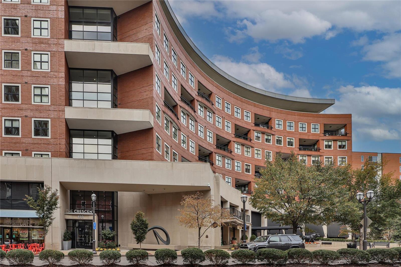 Experience luxury living at its finest in this elegant 2,932 sf residence at the Crescent in Clayton. As you enter this 8th-floor unit, you'll be greeted by wide plank hardwood floors, open floor plan, 10' ceilings, two fireplaces, and a stunning crescent-shaped terrace providing a beautiful view of the park-like garden. Entertain in style with a gourmet kitchen featuring high-end finishes, custom cabinetry, center island, walk-in pantry, and Wolf, Viking, and Subzero appliances. The primary bedroom includes two custom-designed walk-in closets, built-in cabinetry, and spa-like bathroom with double sinks, oversized soaking tub, and large shower. The second en-suite bedroom is thoughtfully located on the opposite side of the home. Add'l features include a laundry room, office, powder room, dry bar, second entrance, and ample storage. Building amenities include 24-hour doorman, valet, on-site manager, concierge, club/media room, fitness center, garden w/ dog park, & secure/heated garage. Location: Interior Unit