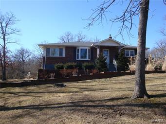 HA816   10 ACRE MINI-FARM located just 2 miles from I-44. The land is gently rolling with a nice wet weather creek. The land has been manicured. It is about 60-70% wooded and the rest pasture. This brick front 1530 SF home has a full finished walkout basement. There are two bedrooms, one bath, kitchen, breakfast room, dining room and living room on the main floor. The kitchen has a range, dishwasher, eating bar and two pantry closets. The full basement has a family room with wood stove, two bedrooms and one full bath. Utility room has a sink area, washer dryer area, the gas furnace and water heater. The basement has two walkout areas to the 10x32 concrete patio. The Western Cedar deck is 12x12 with a handicap ramp addition. The interior of the home has recently been painted. The updates include vinyl TI windows (3 yrs old), HVAC (5 yrs old), shingles (4 yrs), and the septic was pumped out about 3 yrs ago. There is a garden shed. Property is fenced and cross-fenced.