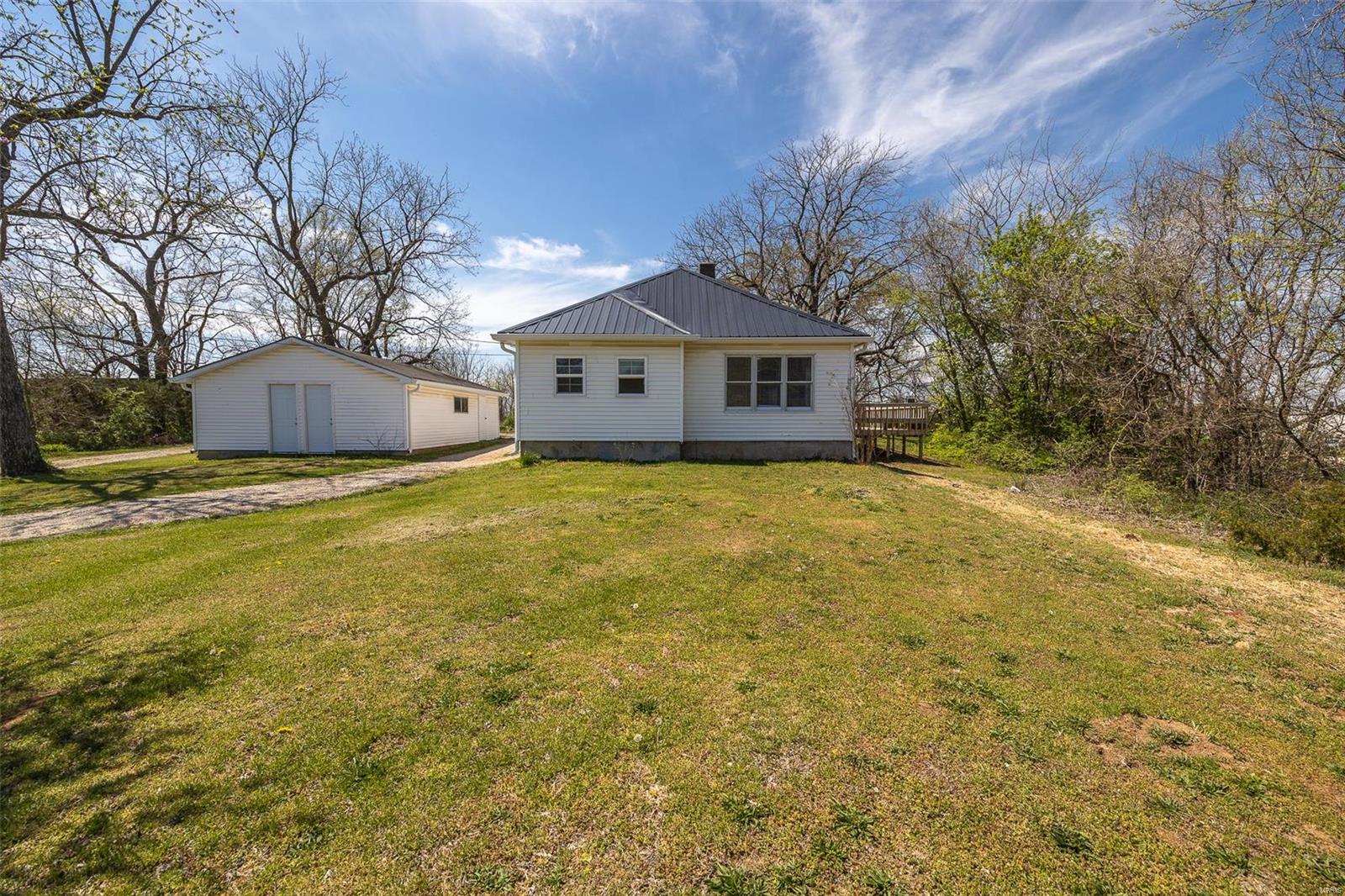 This 3 bedroom, 1 1/2 bathroom home has had many new updates including plumbing, electrical, HVAC, metal roof, vinyl plank flooring, carpet, and more! This home also contains a bonus room that could be utilized as an office, nursery, or even a fourth bedroom-the possibilities are endless! The outdoor space for this property is fantastic for these upcoming warm evenings! This large one acre lot has a circle driveway and an incredible outbuilding that includes three separate access doors to house all of those extra storage items you never seem to have room for. The two decks on this home are wonderful for the outdoor cookout and lazy Saturday afternoons we are soon to take part in. This move-in ready home is ready for you to take a look! Don't miss out, call today to schedule your private tour!