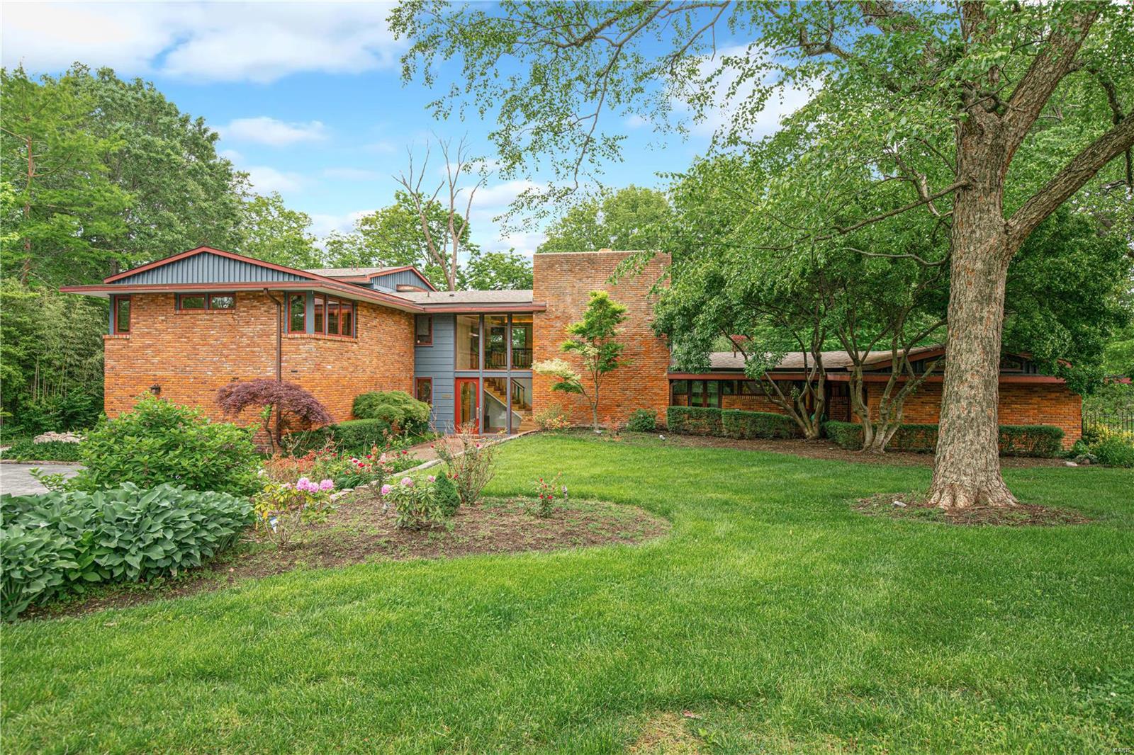 Designed by noted architect Ted Christner is this important mid-century home located on a 1.3+ acre lot. Located in the Ladue School District. This home features a main floor primary suite with a luxurious bathroom, walk-in closet, vaulted ceiling, and doors that lead out to the pool area. The main level has an open floor plan with living room, dining room & recreation room. The hallmark of this house is the abundance of floor to ceiling windows that look out onto the lush landscaping. The kitchen features granite counters, Thermador gas cooktop & dual ovens, and a Subzero refrigerator. Off the kitchen is a large pantry and mudroom with cubbies. On the second level are 4 bedrooms, 3 full baths, and a 6th bedroom option or upstairs office. Laundry on the main and second floors. Lovely pool and workshop outbuilding. Fenced yard.