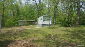 Beautiful 3.038-acre lot in Wappapello Lake area.  Property butts up against the Corps of Engineers lake property.    The lot has road frontage, with a very nice cleared area, and Currently, there are 2 camping trailers on the property, but the owner is selling as a vacant land lot.  There is also a small shed with overhang, perfect for storing a boat etc.  The property has county water, electric, and a septic system.  Septic system condition is unknown.  Possibilities of a lake view with some tree clearing.