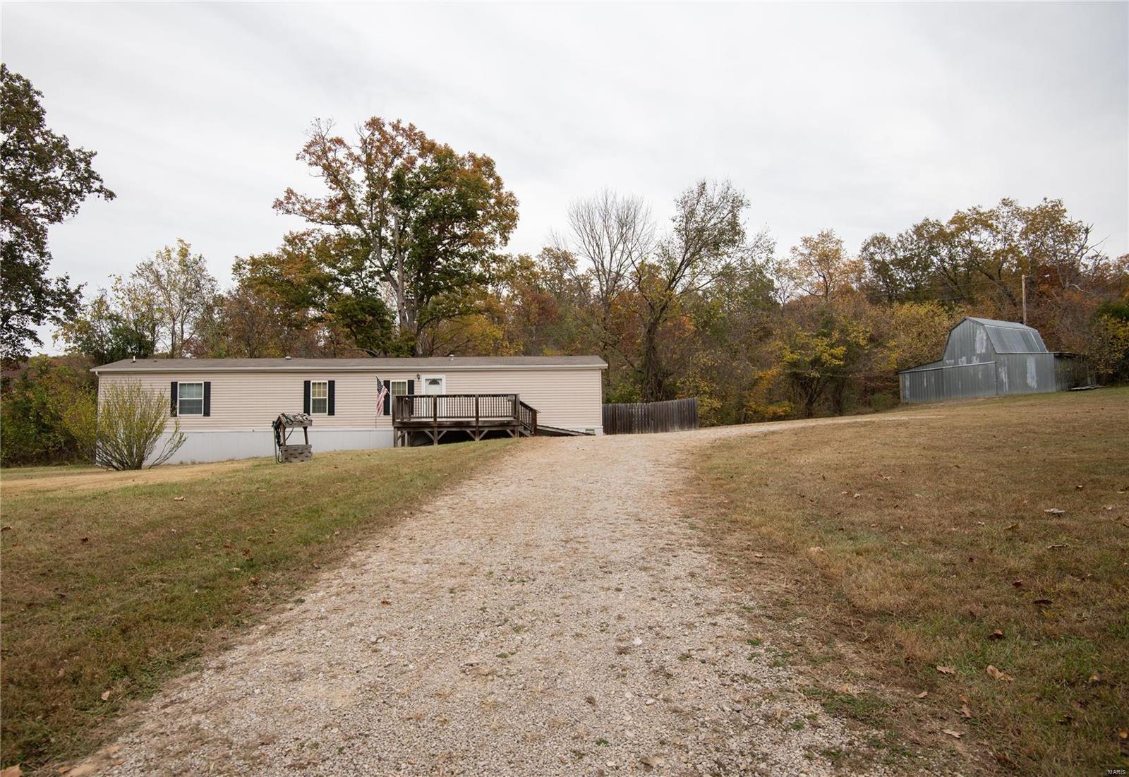 Peace and quiet is what you will find at 3290 Sleepy Hollow! Home, well and septic all new in 2011. Home is well cared for, sits on 3.35+/- acres & is mostly surrounded by trees & woods.  The seller spared no expense when picking out this home! It has 2x6 construction walls with extra insulation in the walls & under the home. The skirting was upgraded to a heavy-duty insulated skirting with auto-opening vents.  The eat-in kitchen is nice size, with lots of cabinets & countertop space. The master bedroom offers a large walk-in closet, & a spacious bathroom with French doors, double sinks, separate tub & shower, & extra cabinets for storage!
The back yard is partially fenced in with wood privacy fencing, & the front and side yards are open with lots of space to spread out.  There's a small barn on the property as well that offers 3 horse-size stalls. It wouldn't take much to start your own mini farm here! Don't let this one pass by, schedule your showing today! Home is being sold as-is.