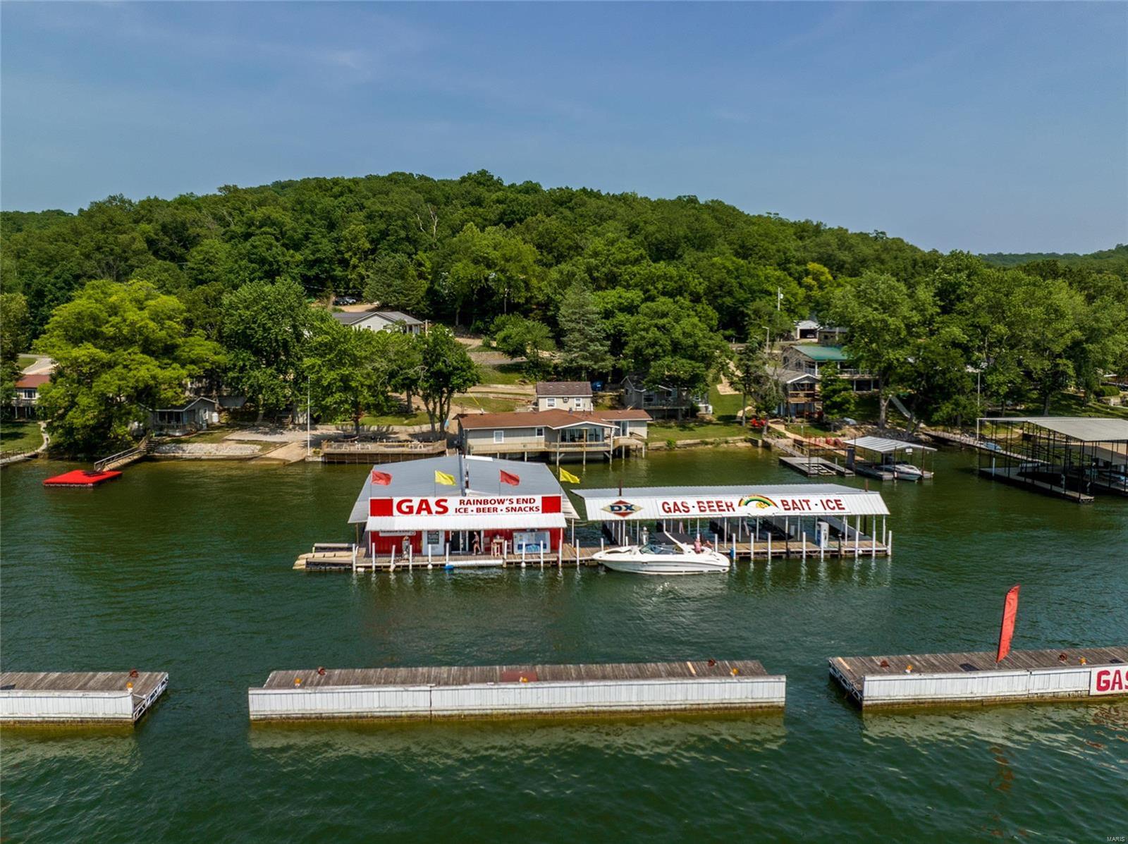MUST have an appt as this is an active business. Fantastic opportunity to own a profitable & popular marina & resort on the Lake of the Ozarks in a PRIME location by water at the intersection of the Big and Little Niangua! The marina is largely protected by 3 massive wave breaks (huge bonus for gas customers) and comes equipped with a c-store, 10 boat slips, 3 jet ski lifts & 2 jet ski fueling ports. A 4000 gallon, dual wall flameshield tank feeds three dual-sided pumps along 125 feet of dock allowing service for up to 7 watercraft at a time. The resort area features 6 lakefront cabins and amazing views along 268 ft of shoreline, boat ramp, private swim deck and huge martini deck for guests. 4 cabins are 2bed/1bth and can sleep 6-8 guests, 1 cabin is a 1bed/1bth currently used for dock operations but could be rented. The 2bed/2bth owner's house is uniquely positioned at the waters edge with a large private deck and 2-car garage. Already profitable, there's HUGE upside potential here!
