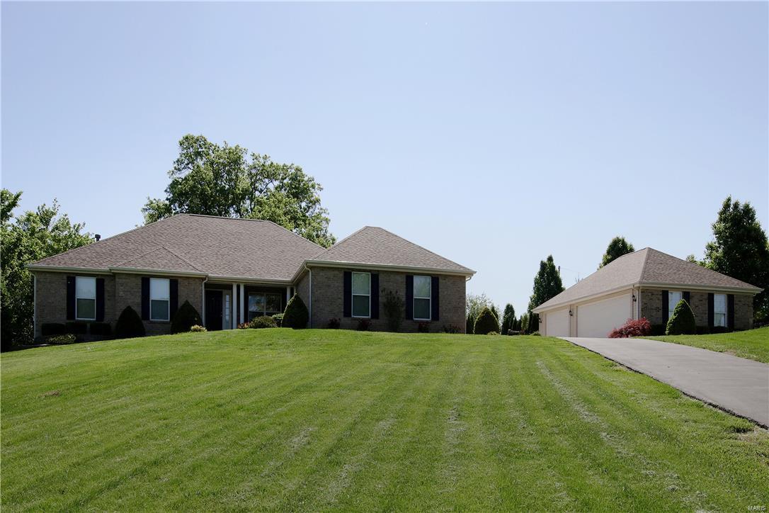 Summer  awaits with your own private in-ground pool on 2.74 acres!  Private country living but close to shopping & Hwy's.   Great curb appeal w/2 car attached garage plus a 3 car detached garage.  Wait till you see all the gorgeous tile work throughout the home, just beautiful!  Dining room w/arch entries, columns & is open to the great room.  Vaulted great room w/beautiful stone wall & gas fireplace.  Kitchen w/center island/bar w/granite top, cabinets w/pull out drawers, tile backsplash, planning desk & stainless steel appliances.  Screened in porch & deck over look the private yard.  7in baseboards main level, central vac, crown molding & wrought iron spindles on the stairs to the lower level.  Coffered ceiling & walk-in closet in the master bedroom. Vaulted master bath w/jet tub, adult height vanity & separate shower.  W/O LL w/big rec area/game room, several bedrooms, a den, full bath & storage area. The in-ground pool's liner new 2016 &  the pump new 2015. Come see for yourself!