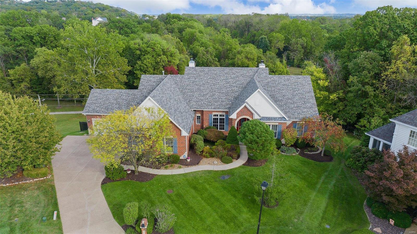 This exceptional Arbor Home, atrium split bedroom ranch w/ 4 car garage backs to Katy Trail on near 1 acre lot. Lot has been transformed into the perfect oasis complete with pool & hot tub. Stunning views await as you peer through the oversized atrium windows upon entry. Features soaring 11 ft. ceilings, extensive molding & millwork, beautiful hardwood flooring, built in surround sound systems and custom woodwork. Foyer flanks formal dining featuring magnificent crown molding w/ custom tray ceiling as well as formal study. Chef's kitchen with custom island paired with elegant granite countertops and SS appliances. The master suite features coffered ceilings, surround sound system & ensuite with private water closet and a generous closet. Enjoy adjacent enclosed screened porch overlooking serene views! Secondary bedrooms are adjoined w/ JacknJill.  Lower level includes media room w/ custom tray ceiling & sound system, rec. room, kitchenette/bar, fireplace and addtl bedroom w/ full bath.