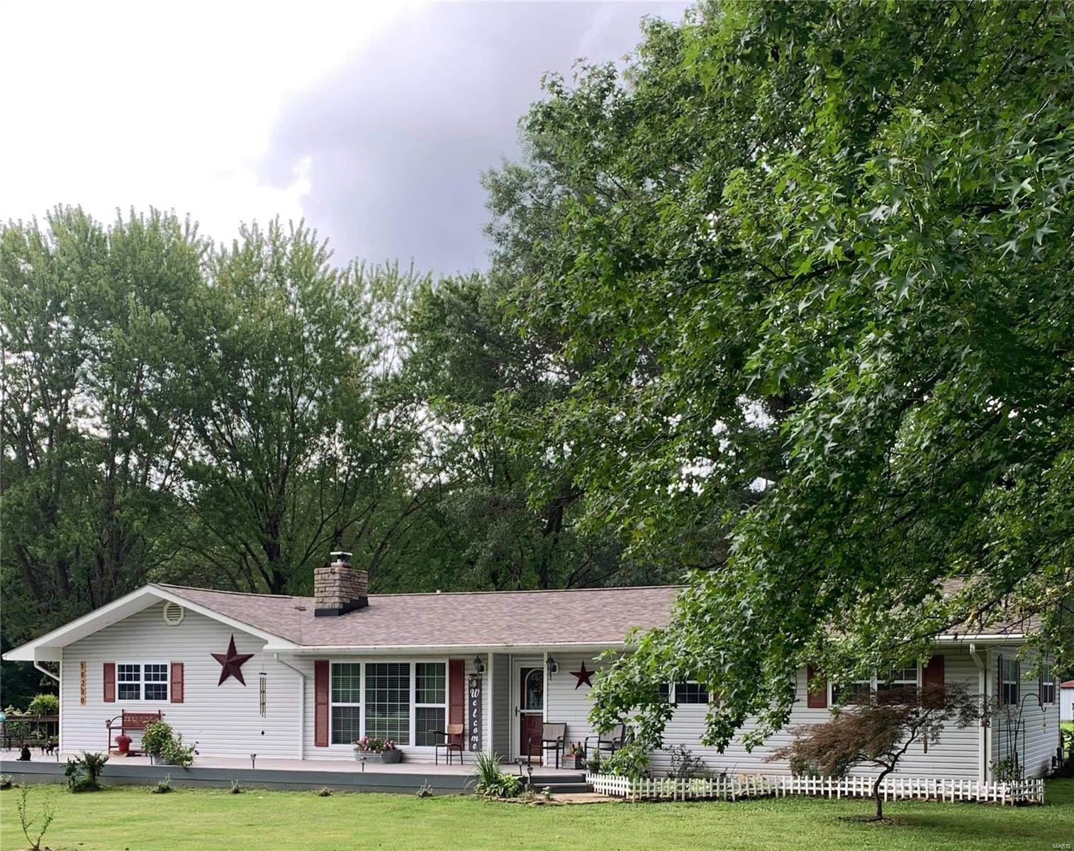 This lovely 3 bedroom, 2 bathroom home sits on a little over 5 acres. Hardwood floors throughout the living room, formal dining room, and bedrooms. Updated kitchen in 2018 with all new stainless appliances, countertops, cabinets and flooring. Enjoy the sounds of nature from your back patio with a built-in firepit. Outside there are several outbuildings for storage, a 2 car detached garage/ workshop area, chicken coop and a barn to keep your horses. All of this on the outskirts of town!! Come check it out.