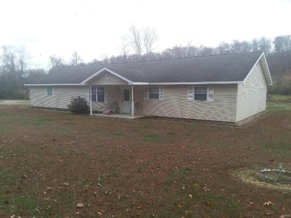 4 plus secluded country acres surround this home located just 8 miles from town. Huge family room and living room.  Kitchen dining combo with an abundance of kitchen cabinets and appliances are included in sale; washer/dryer negotiable.  3rd bedroom does not have a closet, but plenty of space to add one.  Oversized attached two  car garage that includes a workshop area.  There is a singlewide mobile home included on the property, currently rented (could be removed). Both have their own septics; the well is shared.  Must call listing agent to show; no lockbox.  Owner will be present at showings. Call agent for showings.
