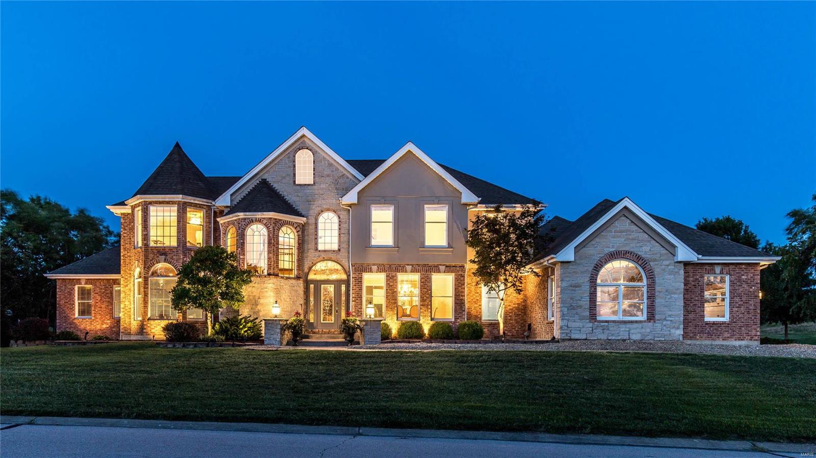 This stunning European-styled Estate home features an impressive brick & stone elevation enhanced by numerous offsets, roof lines & turrets. 2-Sty marble foyer leads to private study with wide bay window & handcrafted bookcase, elegant dining room & spectacular great room with granite fireplace, built-in bookcases & dramatic palladian window that overlooks the 12th hole on the South course. Designer-inspired kitchen with 42” maple cabinetry, stainless steel appliances & center island adjoins vaulted breakfast room & hearth room highlighted by floor-to-ceiling stone fireplace. Coffered master bedroom suite with 14’x10’ walk-in closet & beautifully appointed bath with MicroSilk tub opens to screened porch with hot tub. Front & rear staircases access 3 additional ensuite bedrooms. Lower Level entertainment space includes recreation room with granite bar & fireplace, 2nd kitchen, office, workout room & full bath. Situated on a premium cul-de-sac lot with patio, gunite pool & hot tub.