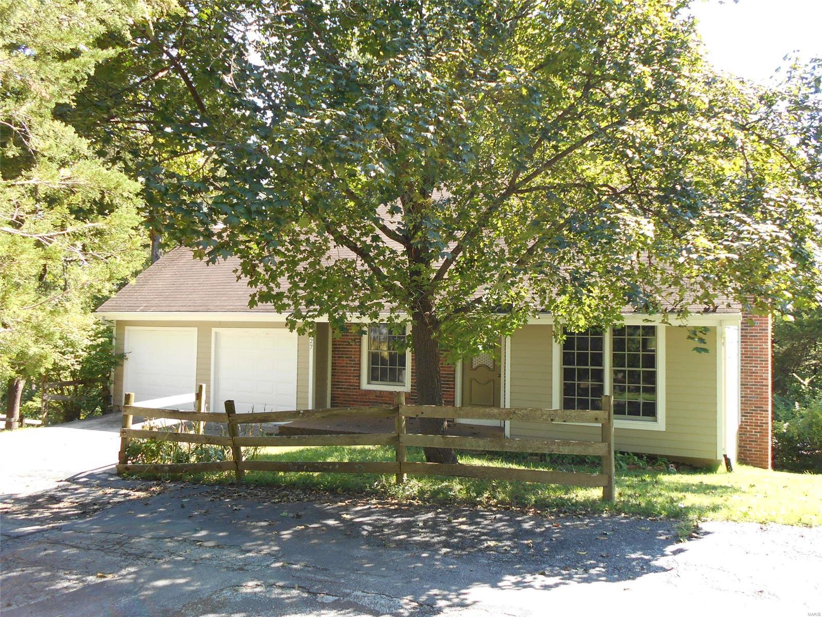Charming 1.5 story home with newer Anderson insulated wood windows, fiberglass cement siding and gutters.  The spacious kitchen features cherry wood cabinets and connects to an adjoining dining/living room.  (Refrigerator, Washer/Dryer stays with the sale of the home).  Master bedroom on main floor comes with large closet and ceiling fan. Upstairs includes two bedrooms, full bath and convenient attic fan.  Additional living space in the walkout lower level includes a woodburning fireplace and extra storage within the utility room.  AC/Furnace/Heat Pump just 6 years old and Water Heater only 6 months old.  Home is being sold as-is. Seller will not be doing any inspections or repairs. May need some updates per your wants, needs and taste but good bones in this comfortable Rockwood School District home.