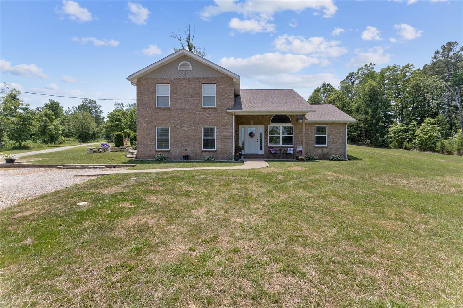 This beautiful 5 bed 2 bath home sits on 6.33 acres just outside town and has tons to offer. Home has been completely remodeled in the last year with brand new HVAC system, new floors, new kitchen cabinets with quartz countertops, new stone wood-burning fireplace and much more! The master suite is large and has walk-in closet, large walk-in tile shower and double vanity. There are four additional bedrooms and 30x40 detached garage with storage room and shelves. High-speed Starlink satellite internet is at the home and seller will leave hardware with the sale. You will enjoy the large yard and patio, great for entertaining friends and family.
