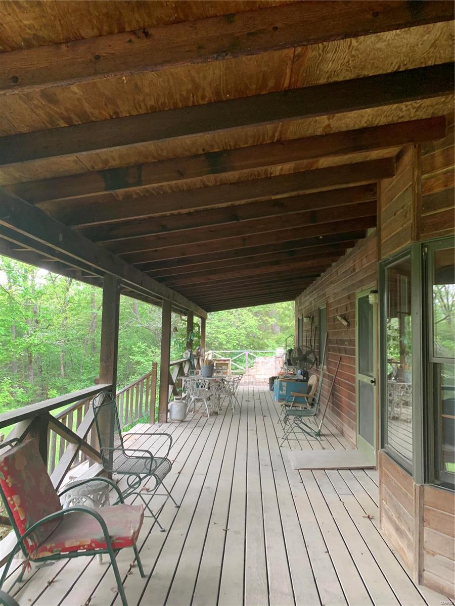 3-BEDROOM,1-1/2-BATH HOME NESTLED ON 20 ACRES IN THE WOODS. ENJOY THE VIEW OF WILDLIFE FROM THE COVERED FRONT PORCH THAT EXPANDS ACROSS THE FRONT OF THE HOME.  SPACIOUS LIVING ROOM, DINING AREA, & KITCHEN. IN ADDITION TO THE WOODS THERE IS A METAL OUTBUILDING AND PASTURE FOR HORSES.