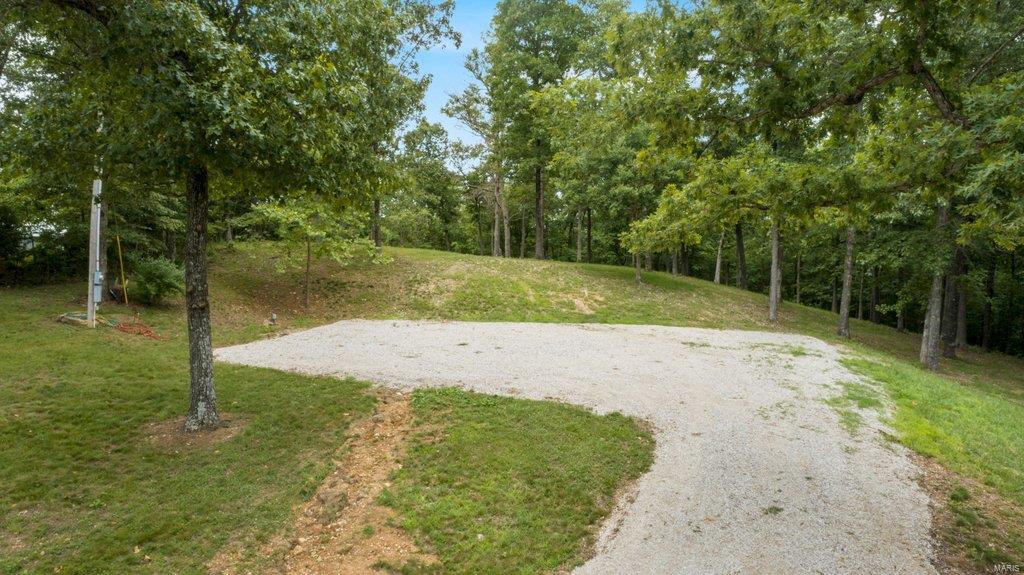 The lake is calling, and there is still time left for boating season. Located in the gated lake community of Lake Kah Tan Da sits a 1.14 acre tract with stunning views of lake 1. This lake development offers approximately 900 acres of property, 3 forty acre lakes and miles of trails. Build your lake home, cabin or use for camping because this lot comes equipped with water and electric readily available. There is a 60' x 40' cleared gravel pad for parking your RV, or an open space ready for building. Along with making memories, this lot gives you the ability to fish, hunt, ride 4-wheel trails (ATV & UTV's), boat, camp, hike, play at the beach and swim. Additional Rooms: In Platted Subdv.