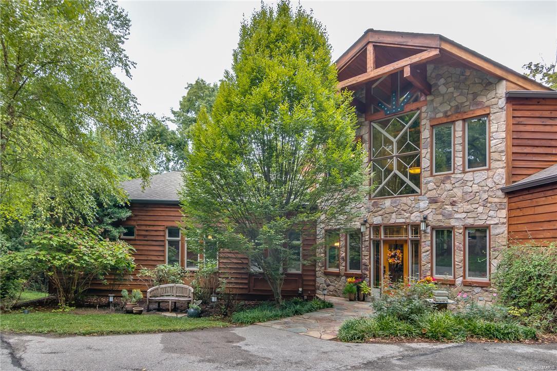 This STUNNING 1.5 story home is an ABSOLUTE SHOWSTOPPER. From the moment you arrive you'll be impressed by the exceptional styling, custom design, gorgeous groundscapes & over 7,800 sqft of finished living area. Situated on a 1.7 acre private lot in the heart of Chesterfield, this property may be the best kept secret in all of West County. ENJOY LUXURY LIVING AT IT’S BEST. This home could be straight from the pages of Architectural Digest or a Luxury Resort photo shoot. The outstanding open floor plan, custom lodge beams, extensive millwork & countless luxury amenities all add to the comfortable & inviting character of the home. This property has all of the quality features & high end finishes that you would expect in a house of this caliber. The exterior living options are unparalleled w/ an amazing 4 season room, outdoor fireplace, spa like pool w/ hot tub & full size sport court. At last, a home for the Buyer who wants it all. Welcome to your personal paradise.