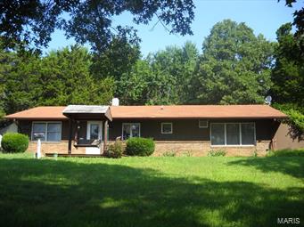 Want Out Of Town? Low Price? Check Out This Earth Home on 5+ Acres! Large Rooms, Kitchen w/Stove, Fridge & Woodburning Stove. Large Living Room & Master Bedroom w/Attached Office Area or Walk-In Closet. Laundry Area & Full Hall Bath w/Walk In Shower. Workshop Behind Home for Storage or Handyman Area. Nice Front Lawn & Mostly Wooded.