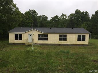 This large manufactured home sets nestled within the woods for plenty of privacy. Featuring 5 bedrooms and 2 full bathrooms on a 10 acre lot with an oversized detached garage/outbuilding. Call today for additional information or to schedule a showing. SpecialListingConditions: Foreclosure