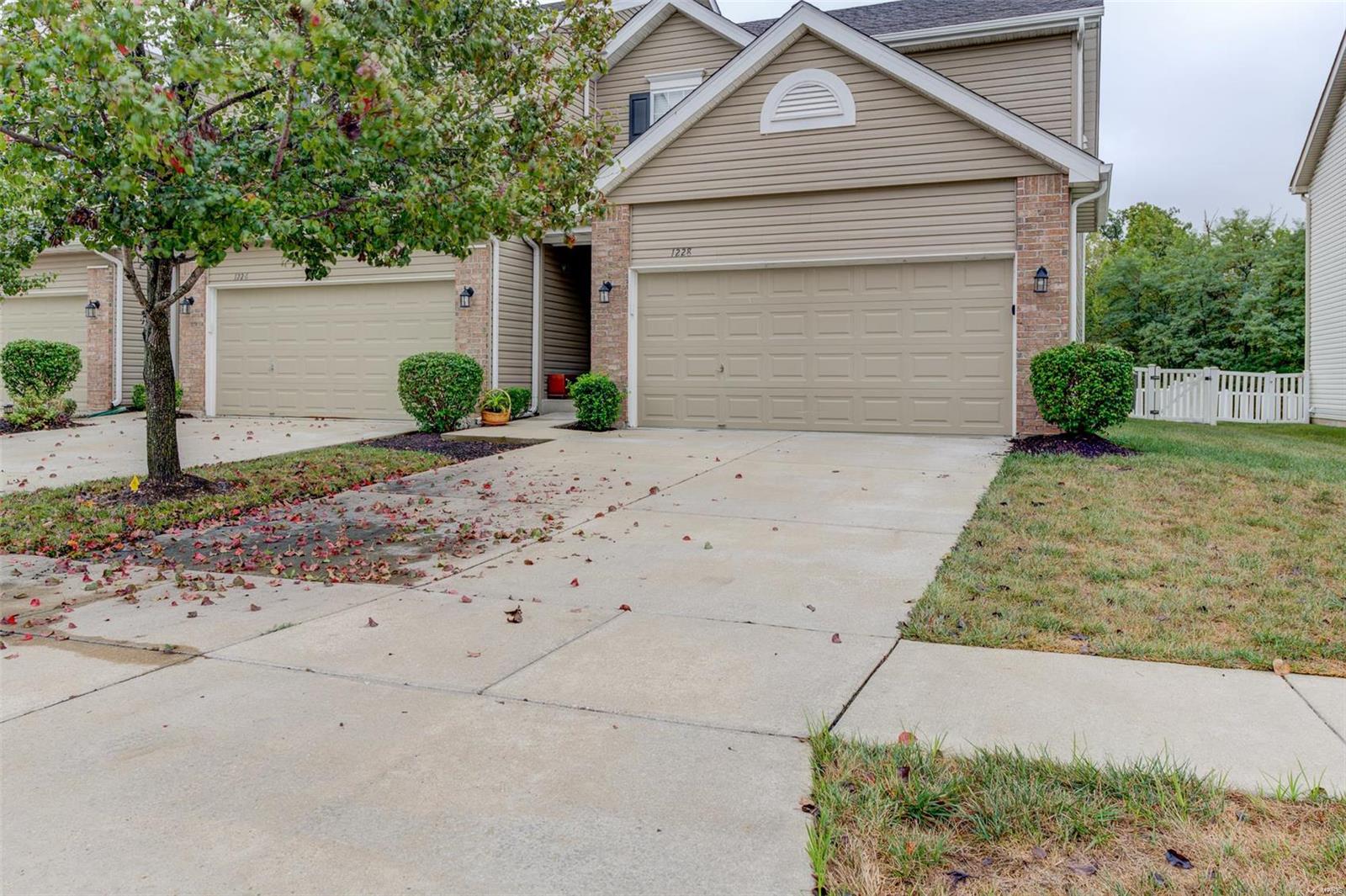 Welcome home to this lovely brick & vinyl townhouse with 2 bdrms, 2.5 baths & 2-car garage!  The entry foyer leads to the spacious living rm with beautiful window treatments & ceiling fan. Adjoining the living rm is the cozy brkfst rm & kitchen, updated with quartz counters, SS appliances, gorgeous backsplash & stainless deep, double sinks.  There's also a handy brkfst bar, pantry & 2 freestanding china cabinets with glass doors.  Rounding out the main level is a half bath sporting a pedestal sink.  Out the slider to the backyard is a large patio & a fenced area (for those furry friends & little ones) overlooking common grnd & trees. The upstairs boasts a spacious primary bdrm with a roomy bathroom and 2 separate walk-in closets as well as a guest bdrm, hall bath, 2 linen closets & loft area. The LL is unfinished, has an egress window & awaits your finishing touches.  Amenities include an inground pool, clubhouse & walking trails.  Great location & great schools!  Don't miss this one!