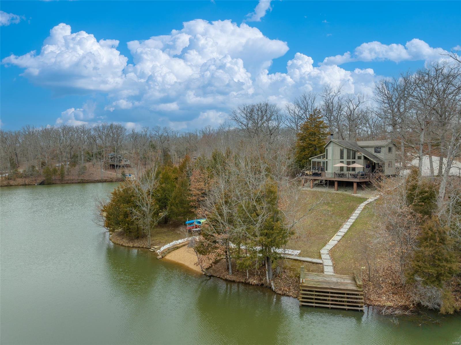 ***OPEN HOUSE CANCELLED.*** Captivating lakefront chalet at Innsbrook Resort features an expansive amount of shoreline and ample outdoor entertainment space. Family or guests will enjoy lake activities from the private dock or beach. How about swapping stories with friends around the firepit? The oversized low maintenance deck offers views of the lake and the surrounding trees provide privacy from neighbors. Notice the covered front porch AND rear porch. Inside, the floor to ceiling stone FP is accented with windows and cedar walls, giving the true cabin feel. The spacious kitchen has a large breakfast bar and huge separate dining space. Four large bedrooms, plus a loft, allow for ample sleeping space. Comfortably sleeps 15! The bunk room is phenomenal. This unbelievable property comes fully furnished, minus a few exceptions. This property is rentable. If you're looking for a large chalet, with plenty of space both inside and outside, and on a great lake, then this one is it!