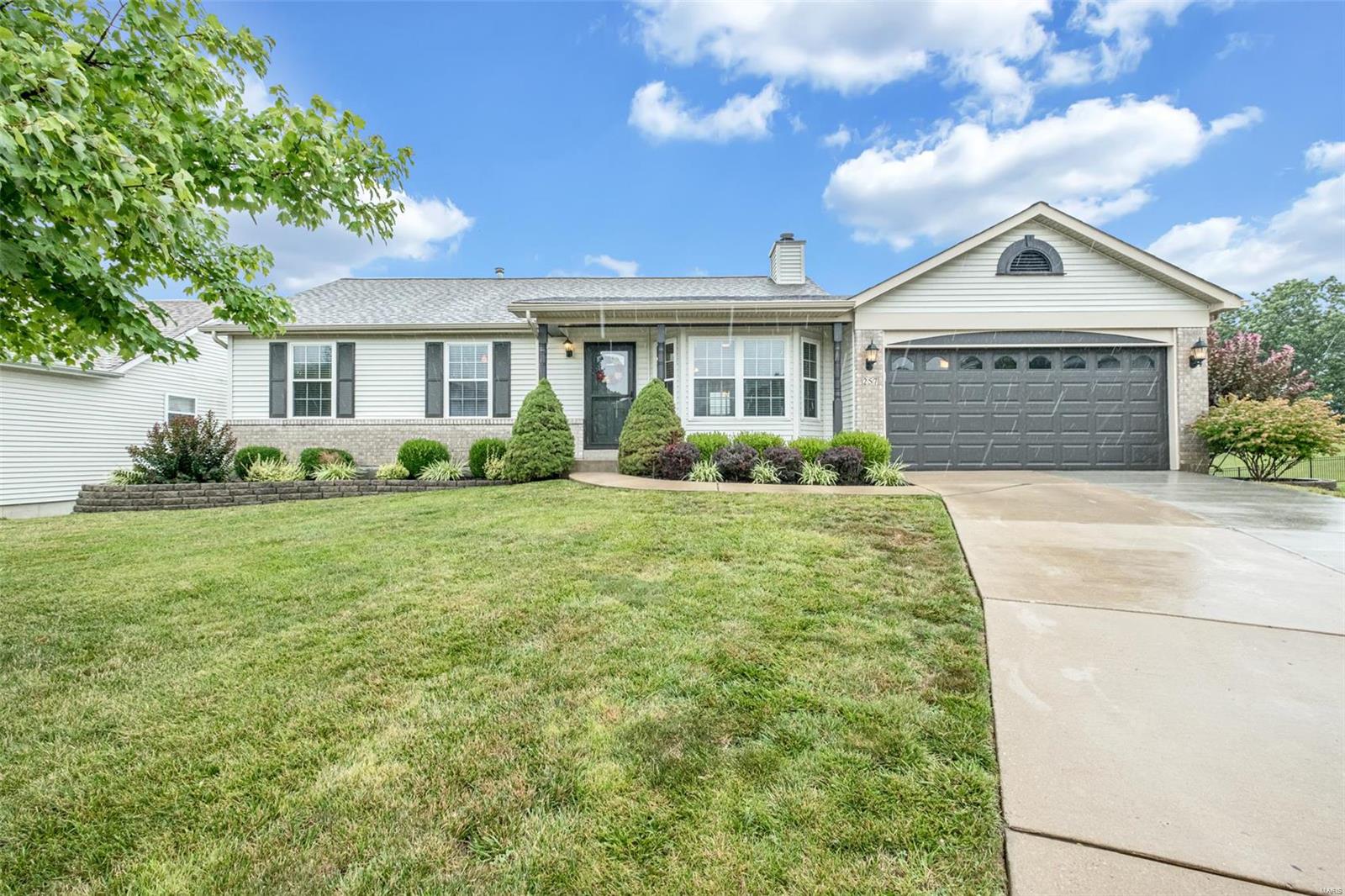 Charming 3bd/2bth home located off Hwy K in O'Fallon! This cozy home has been updated with new carpet, new paint, new double-hung windows-with lifetime warranty, deck has been freshly stained & a new roof! Home features an open floor plan, with hardwood like floors throughout the kitchen and living room. Living room features a brick surround wood-burning fireplace. Kitchen has been updated with new sink, backsplash, and features a pantry. Master bedroom offer on-suite with updated bath. Hall bath has been updated with new vanity and lighting.  Walk-out lower level has a bonus room/sleeping room with large walk-in closet and plenty of room for storage. Come quick - this one will go fast!